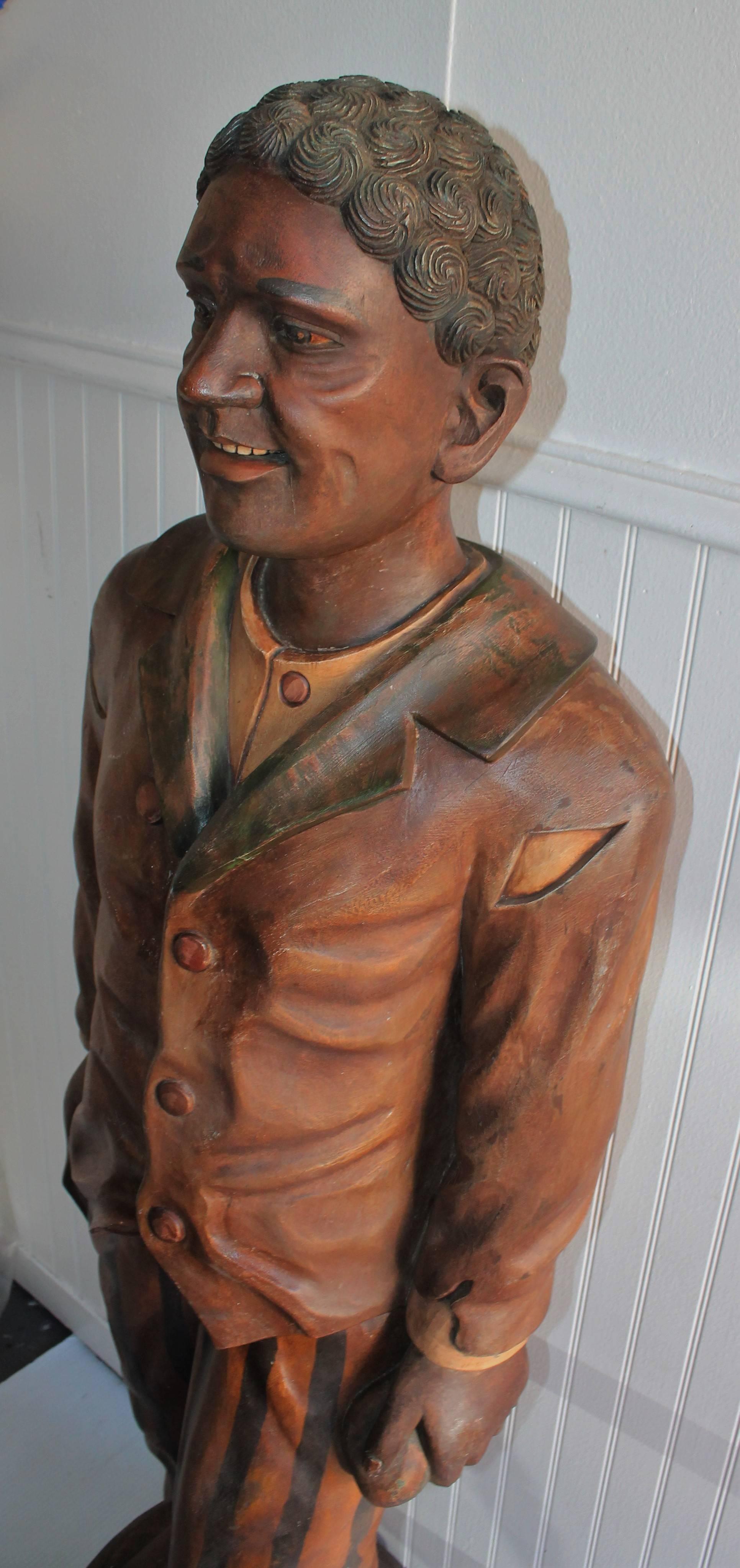 Hand-Carved and Painted 19th Century Cigar Store Figure.
The man is hand carved from one piece of wood. He is probably late 19th century and over painted. The details of the carving is amazing.