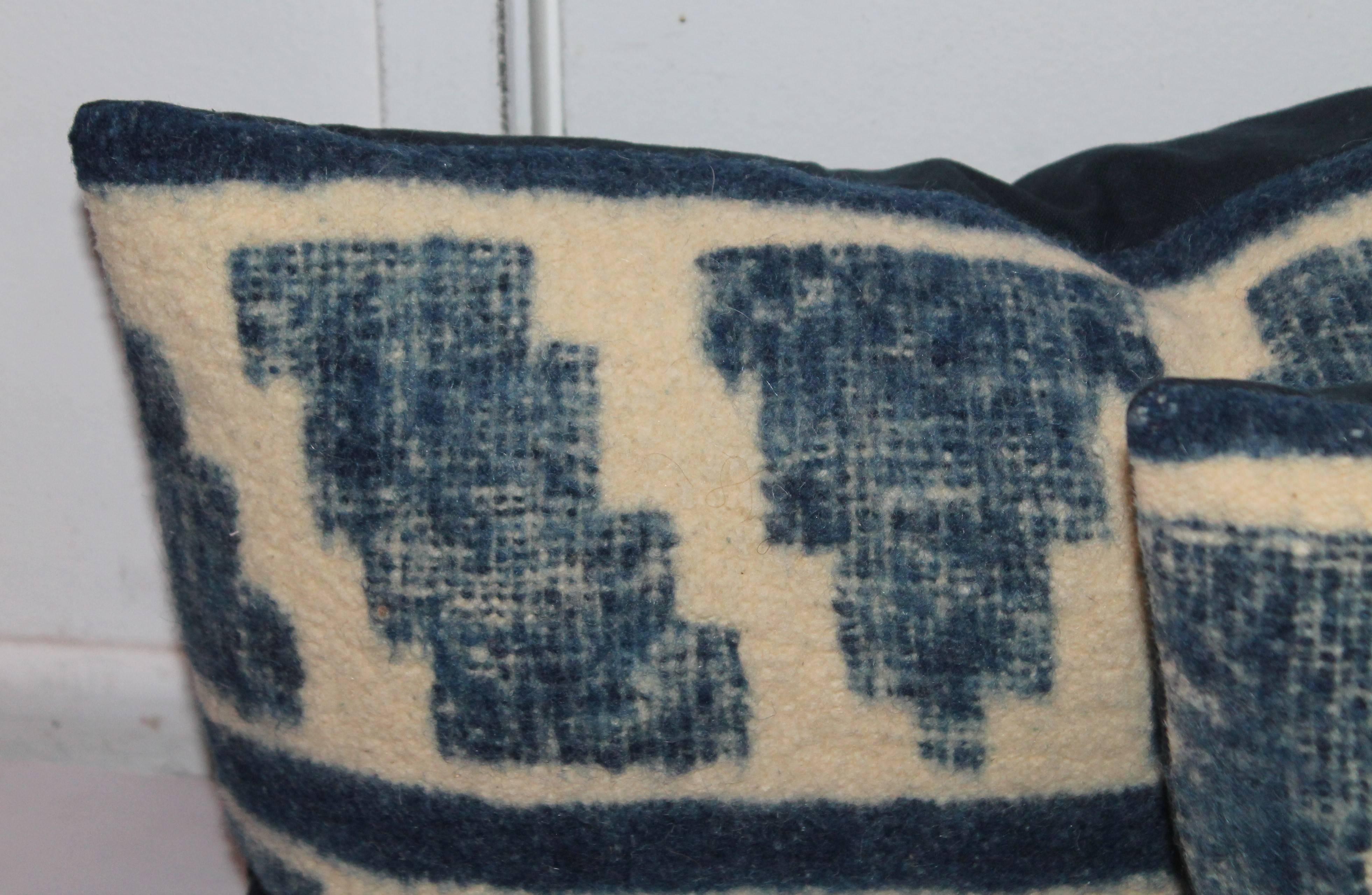 These handwoven Mexican or Peruvian indigo and cream bolster pillows are sold as a match pair. The condition are very good with blue cotton linen backing.