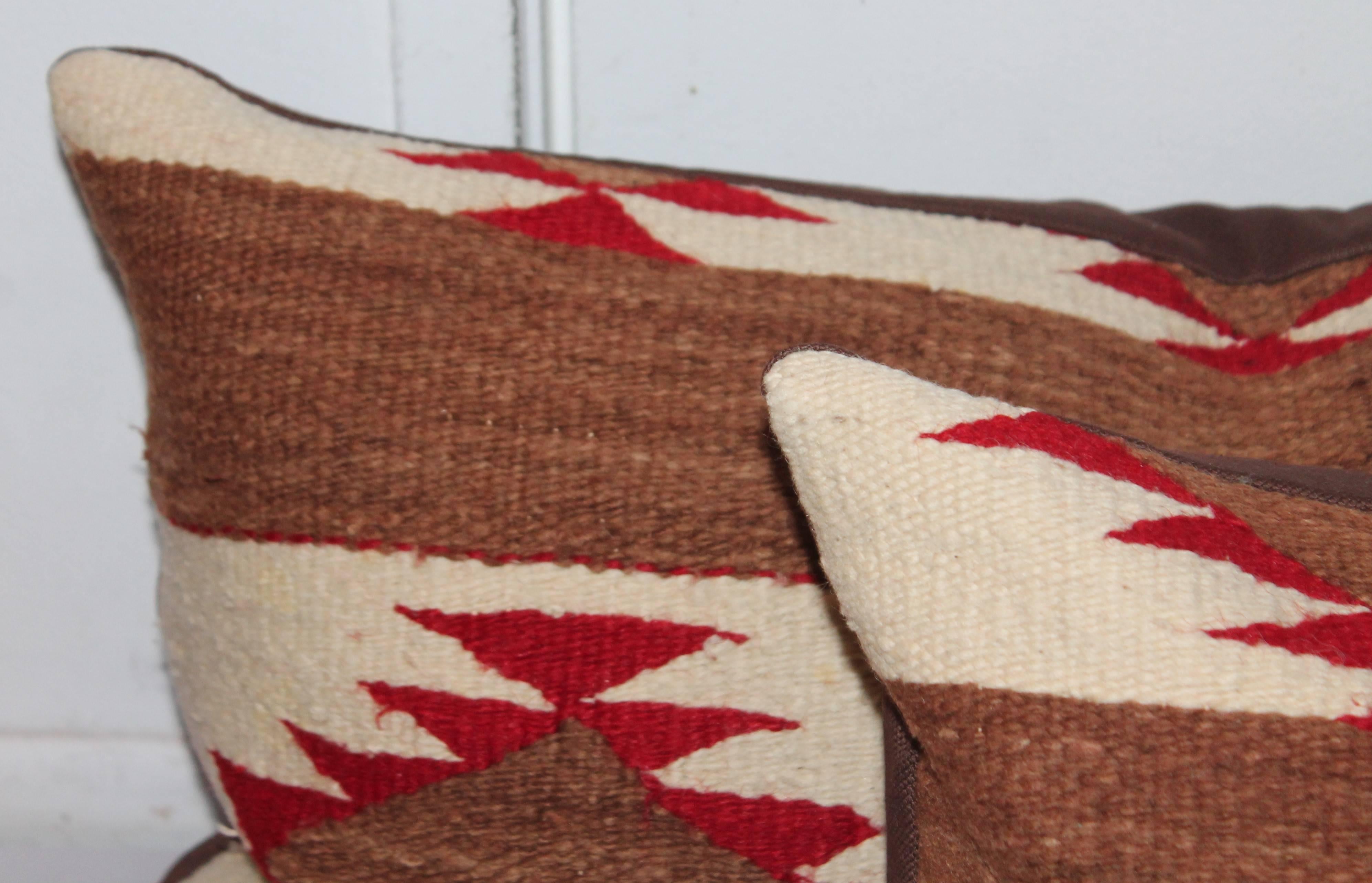 These amazing bolster pillows are handwoven and have brown chocolate linen backings. These pillows were cut from a very early Navajo weaving.
