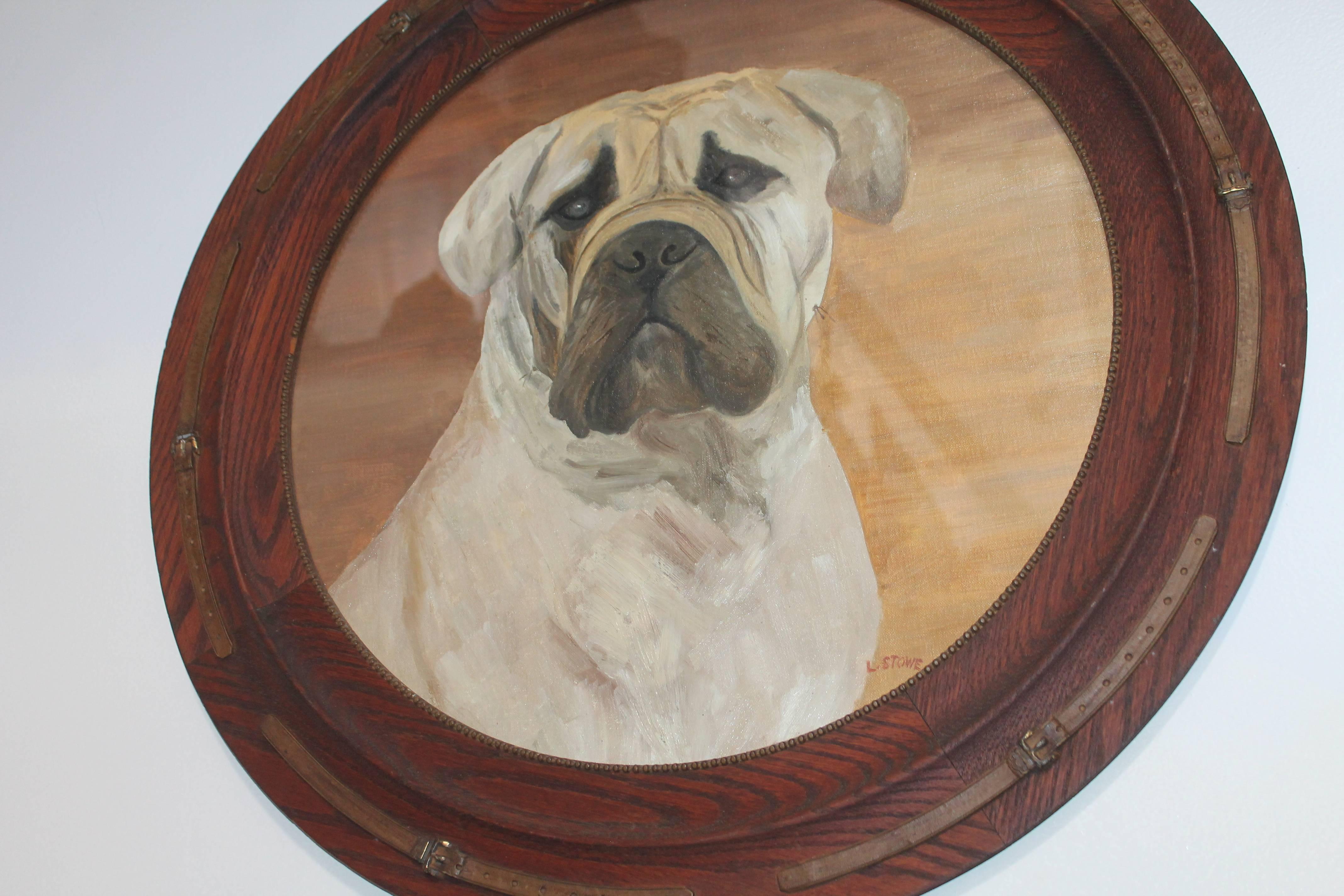 This large oil painting on canvas behind glass is in the original frame. The frame has carved collars in gilded paint all around applique on the oak frame. This most unusual oil painting we believe to be a mastiff dog.