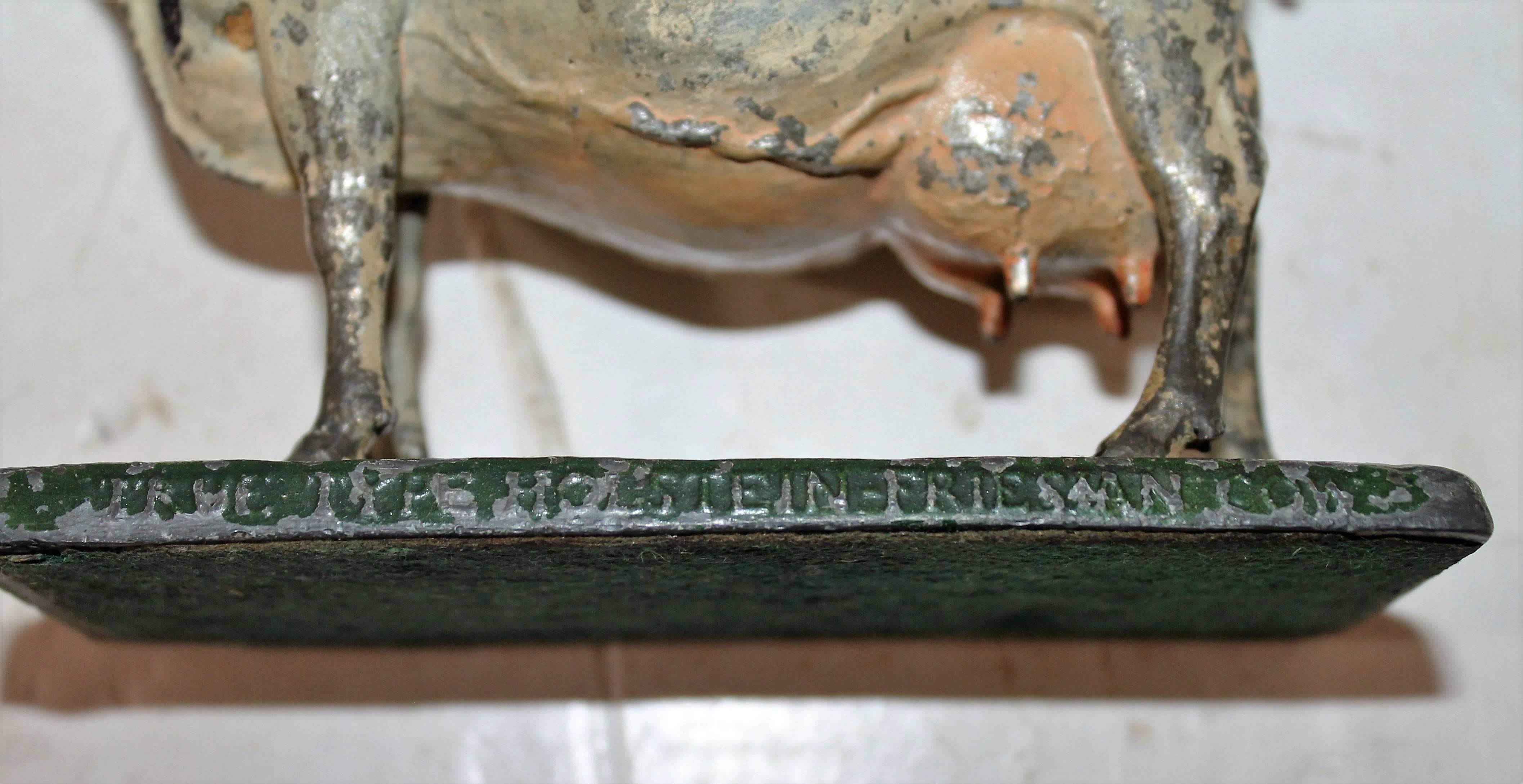 This fantastic iron and zinc original painted cow is in original paint and is embossed 