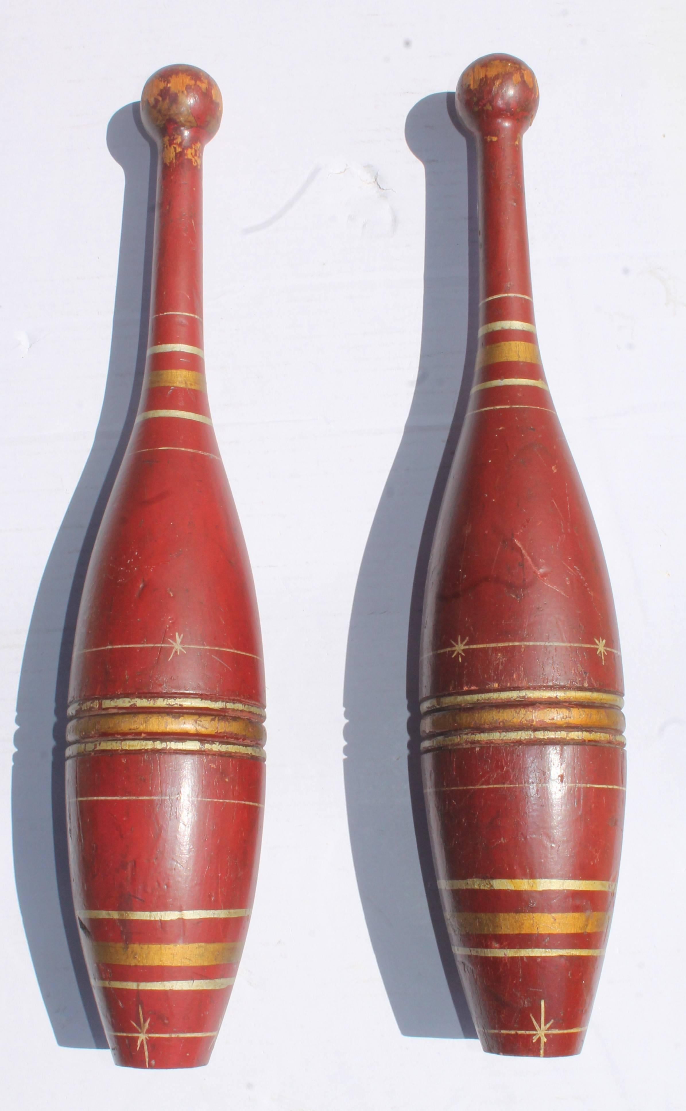 19th century original paint decorated juggling pins from New England. The condition is very good.