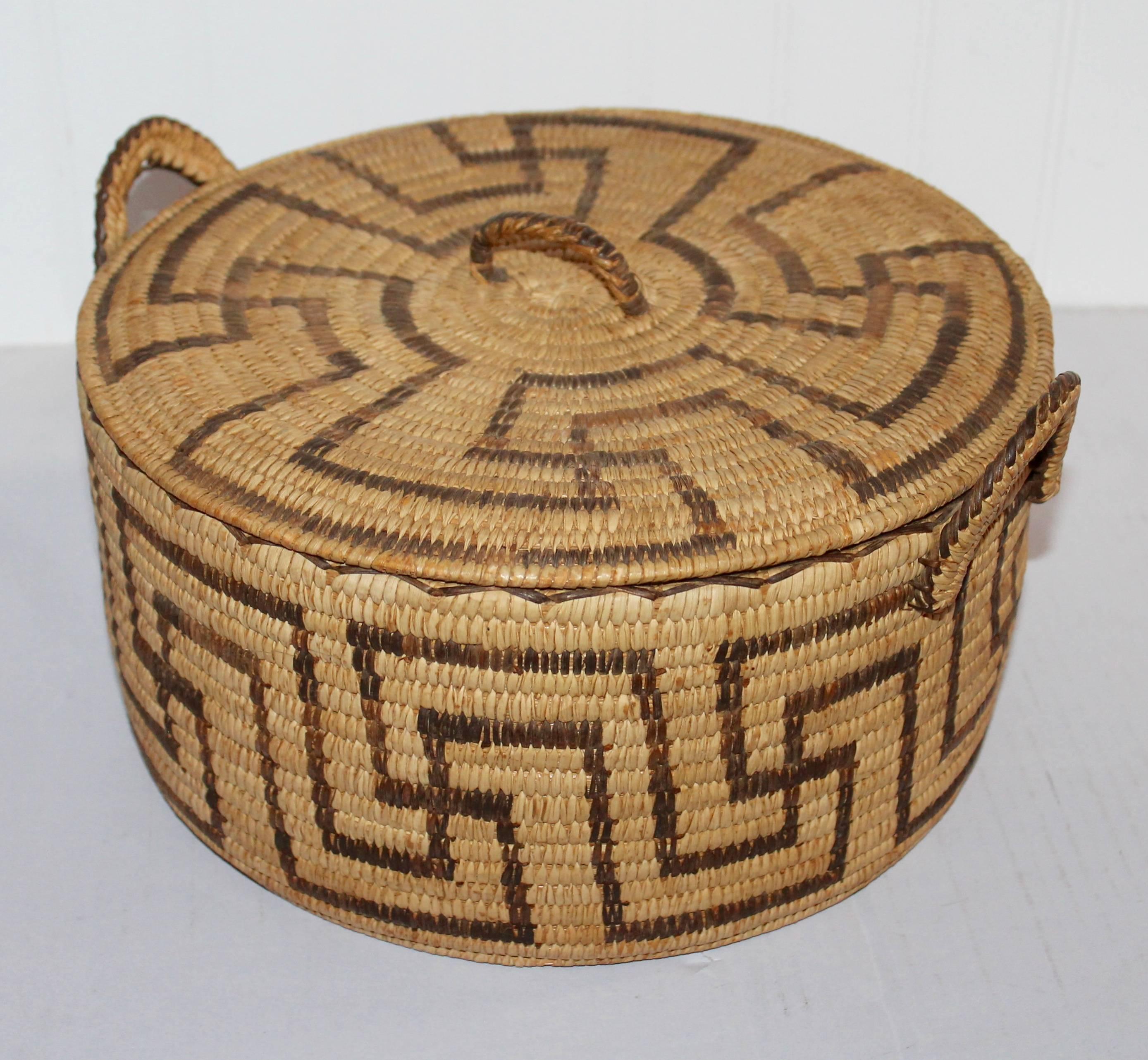 This amazing and quite rare Papago Lided basket s in fine as found condition. This unusual geometric pattern is also the same throughout the lid. The condition is pristine.