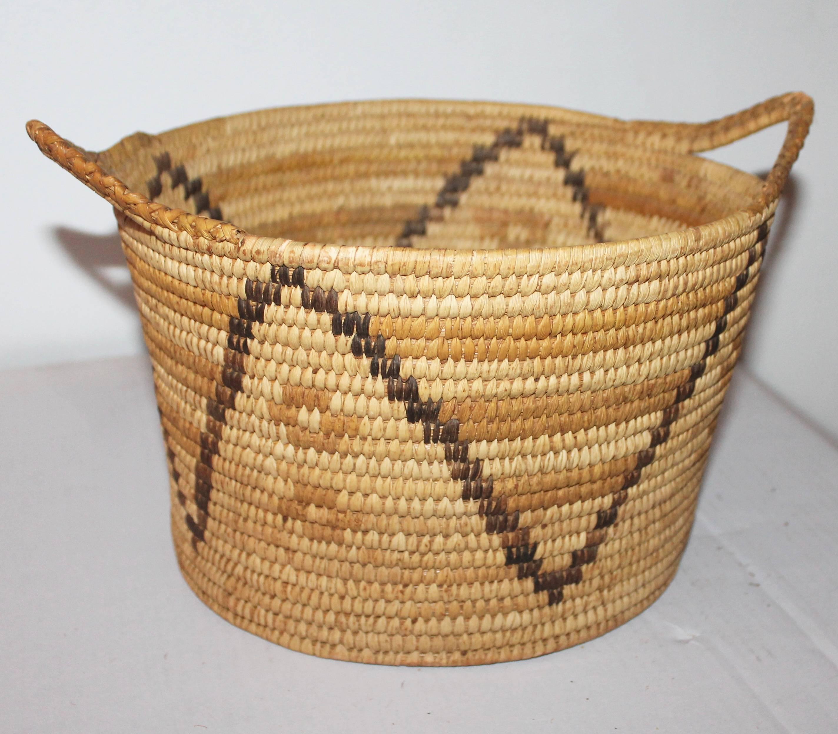 This fine and unusual double handled Papago basket is in good condition. Its simple pattern and fine tight weave makes it very special and unusual.