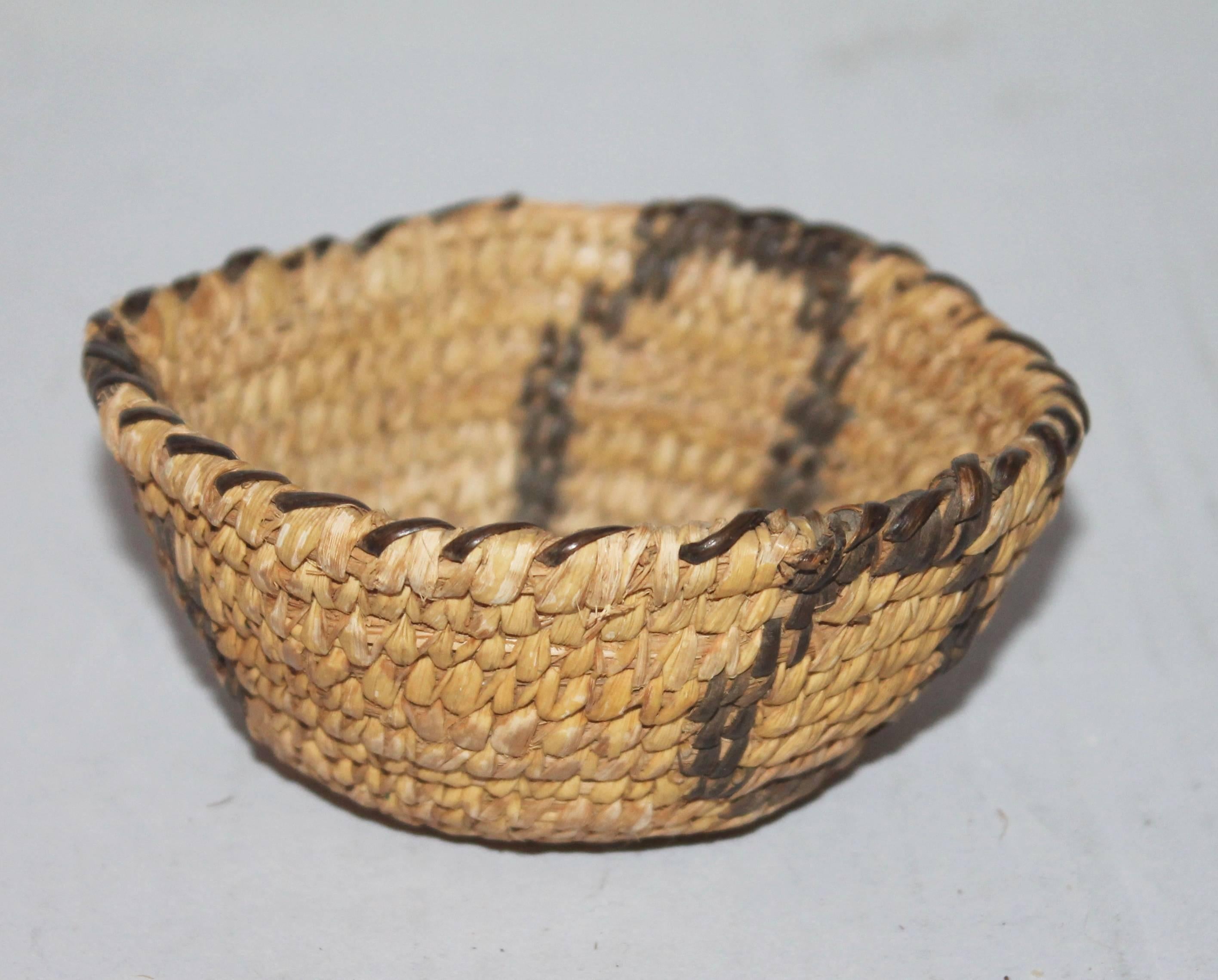 This is a fine example of miniature Indian basketry. This small Papago American Indian basket is a great addition to any Indian basket collection. The condition is very good with minor edge wear in one area.
