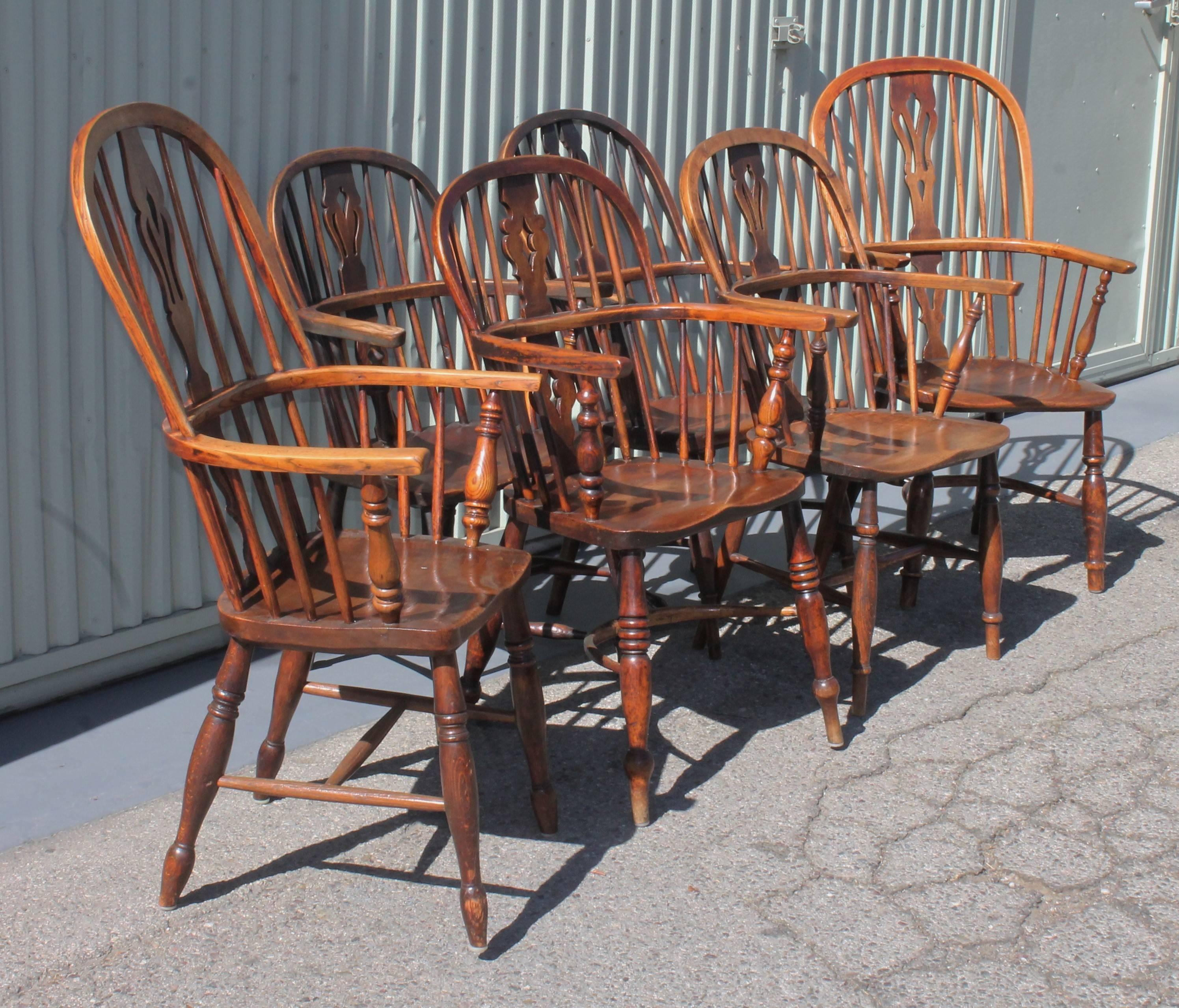 This set of unusual and wonderful aged, worn patina chairs are in good condition. The wear is in areas consistent with age and use. Some have different spindles or shapes. They look fantastic together as a set. The two high back chairs are 42"