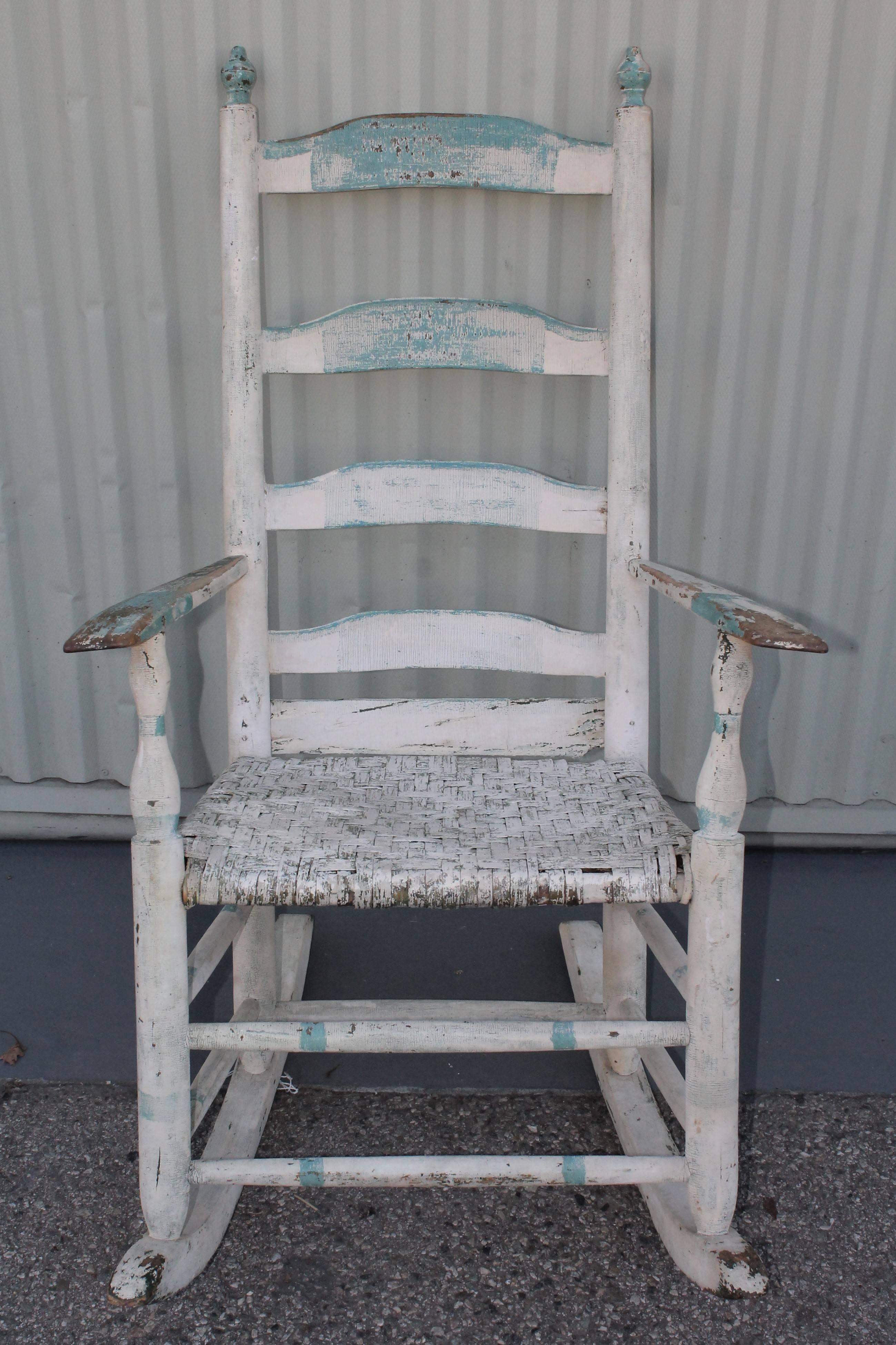 This fine example of Folk Art painted rocking chair. This handwoven splint seat is also original and in very good condition. This rocking chair was found in New England. Wonderful worn and aged patina.