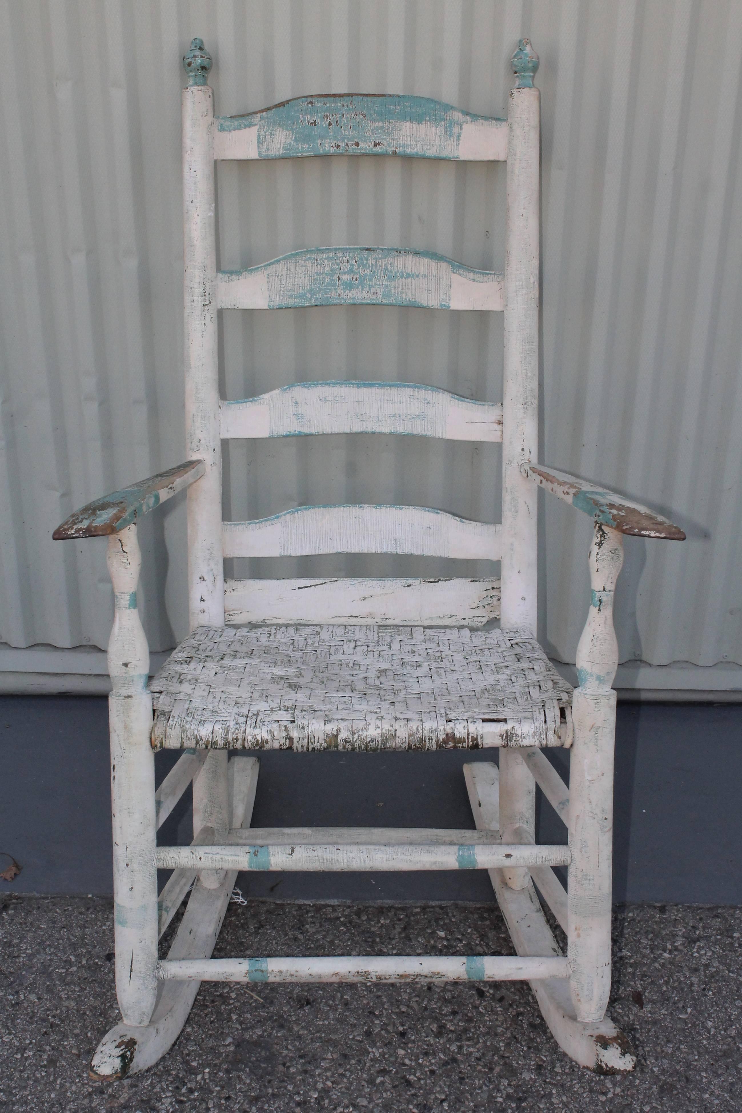 This fine example of Folk Art painted rocking chair. This handwoven splint seat is also original and in very good condition. This rocking chair was found in New England. Wonderful worn and aged patina.