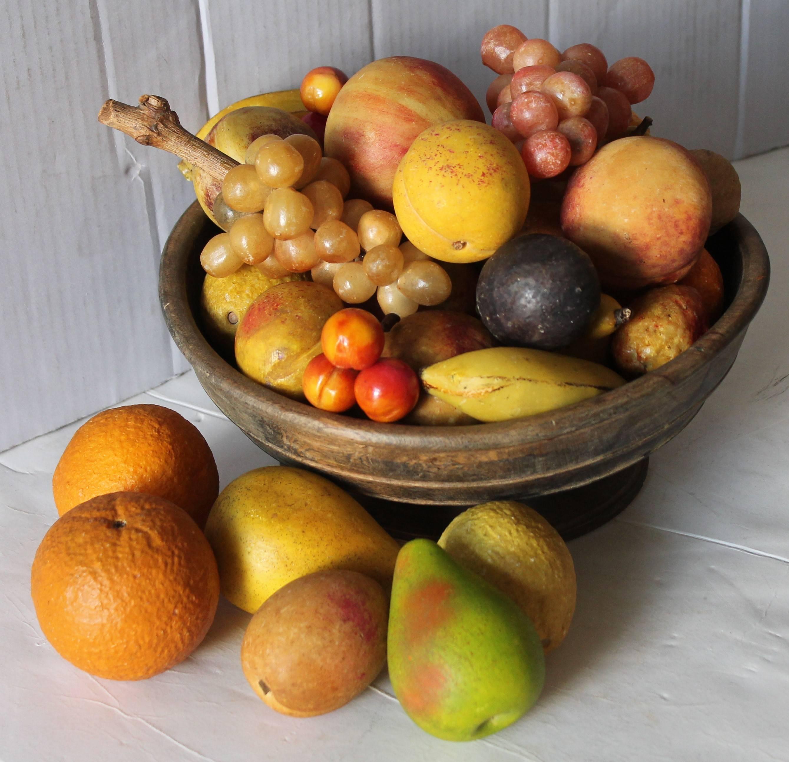 This wonderful collection of 30-piece of folky stone fruit set in a great early 18th century treen bowl. The condition of the stone fruit and wood treen bowl are pristine. Sold as a collection only.
 
