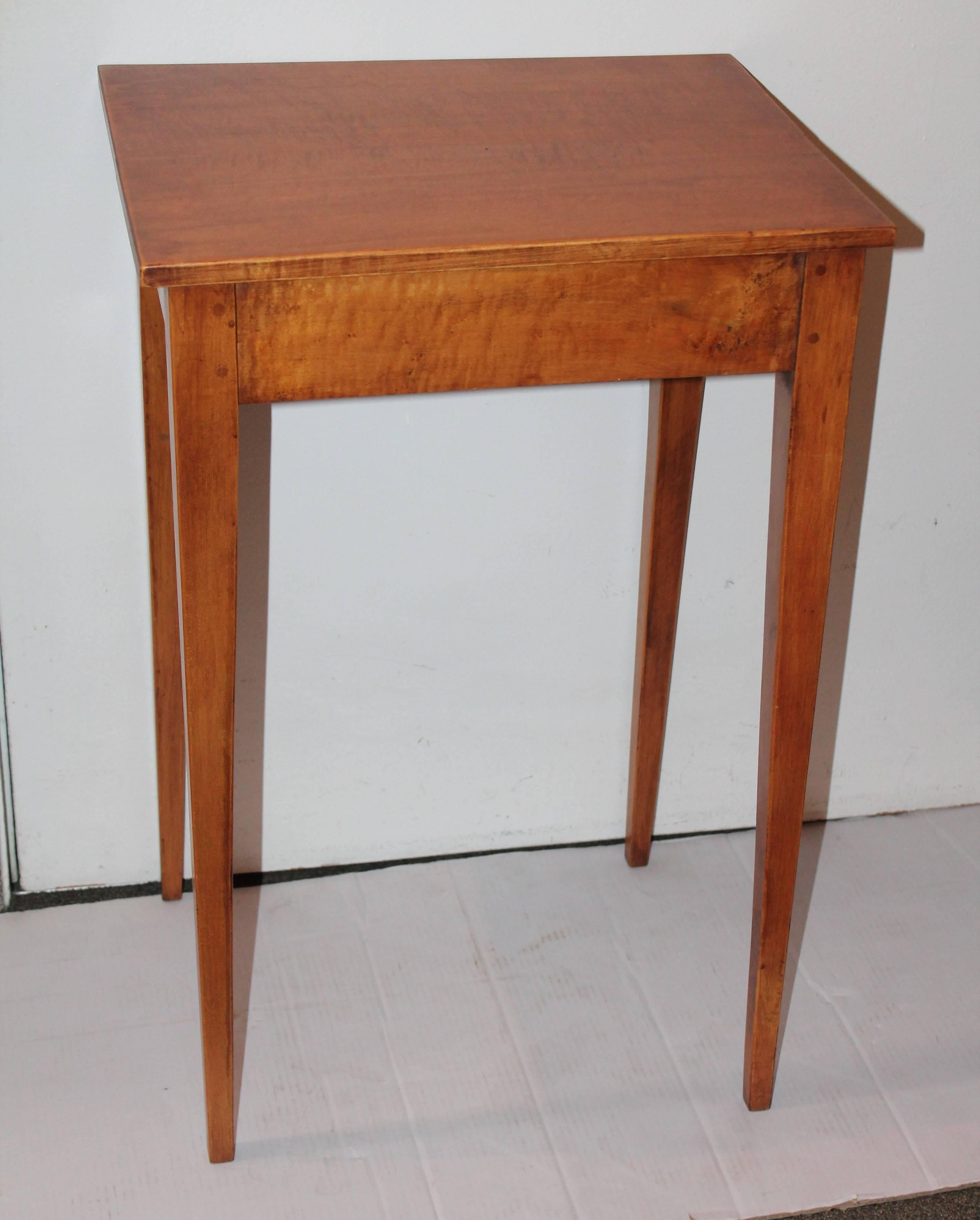 This fine simple lines taper leg table is in the form of Shaker furniture. It is a shaker style form with nice early wood peg construction. The condition is very good.