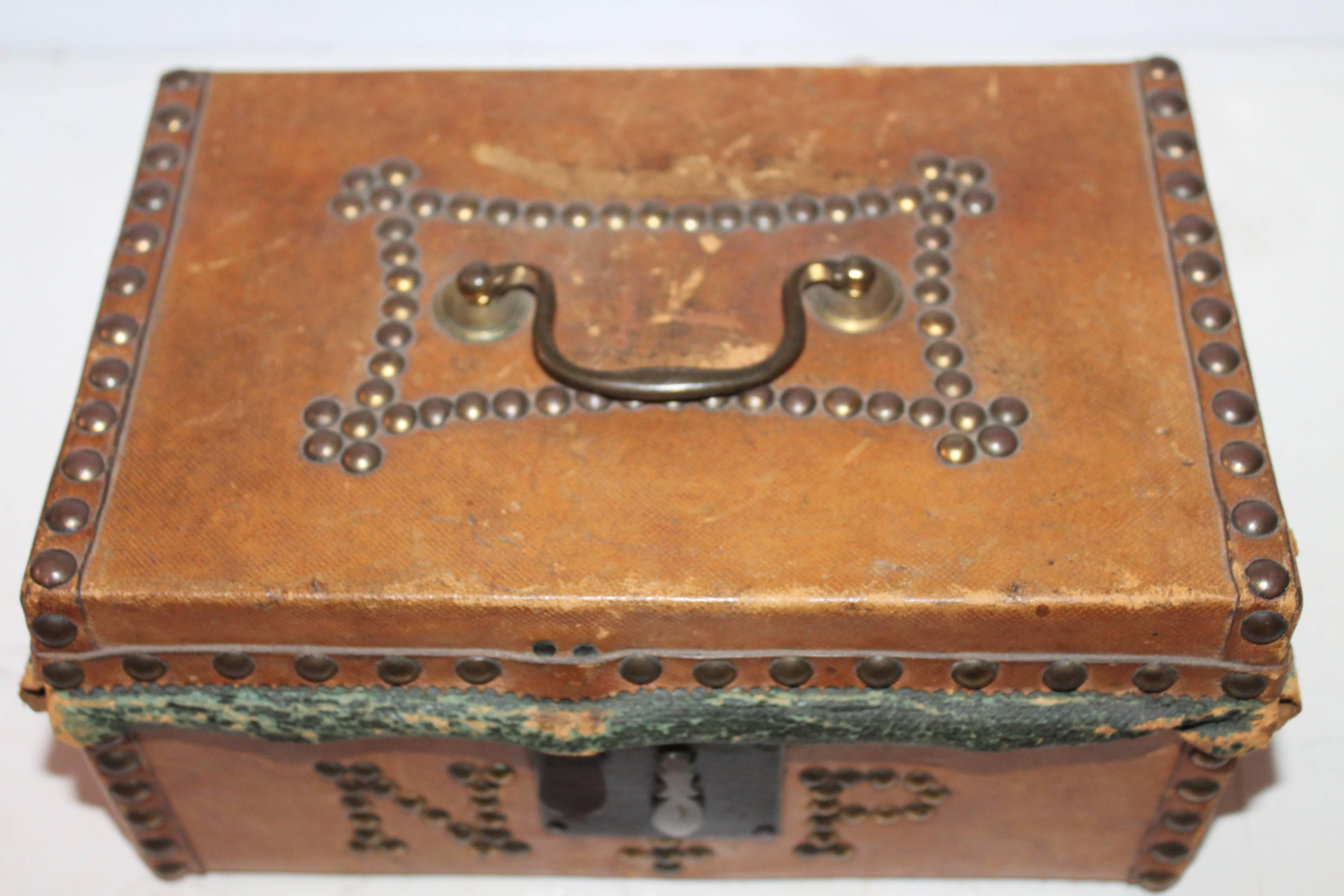 This all original document box is covered in kid glove leather and brass tack button letters and trim. The inside is covered in original painted paper liner and labeled ROBERT BURR / SADDLE & TRUNK MAKER ,HANOVER STREET, NEXT TO CONCERT HALL ,