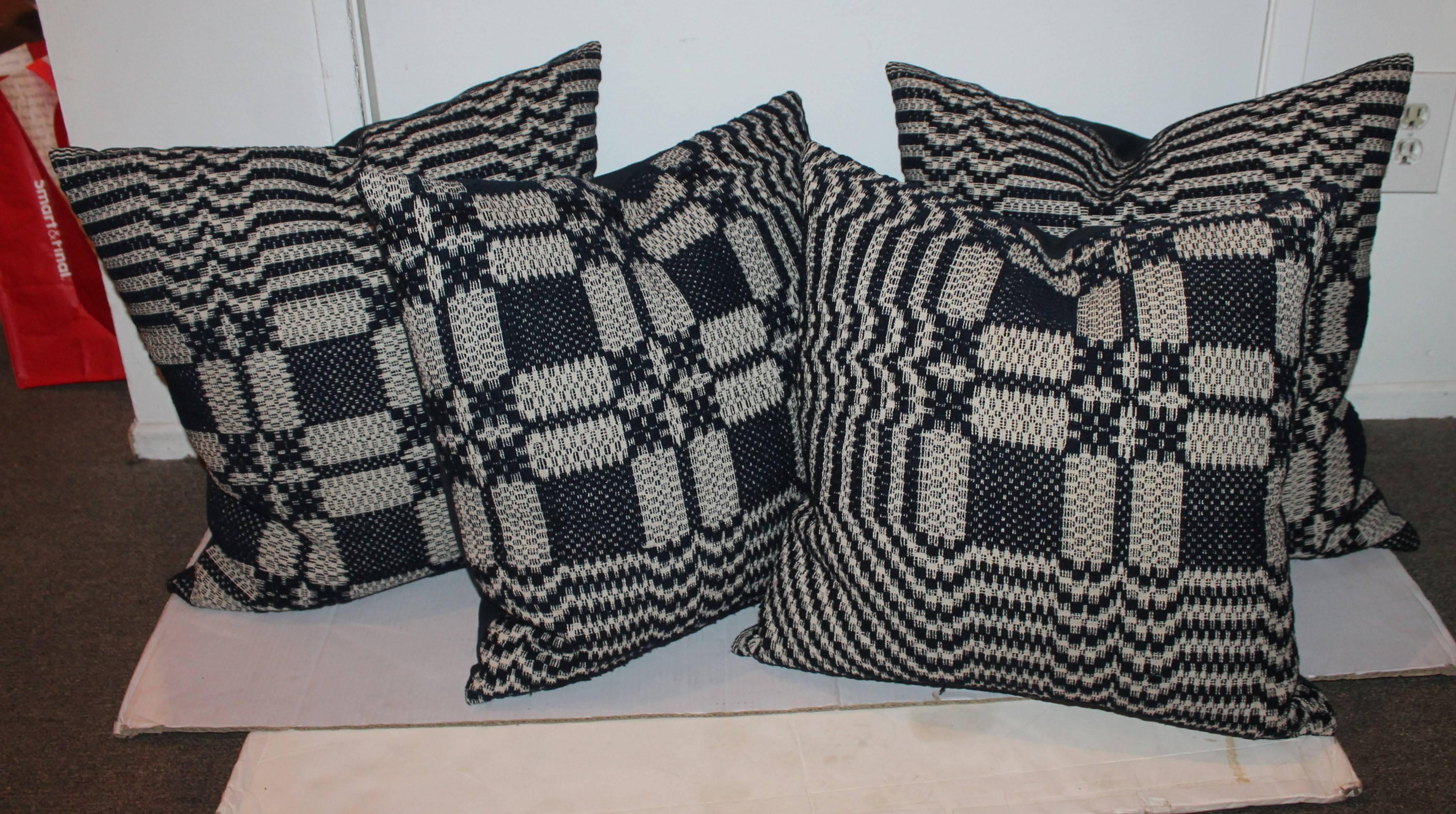 These handwoven coverlet pillows are sold in pairs. We have two pairs of 20 x 20 and two pairs of 22 x 22. The condition is very good and the backings are indigo blue cotton linen.