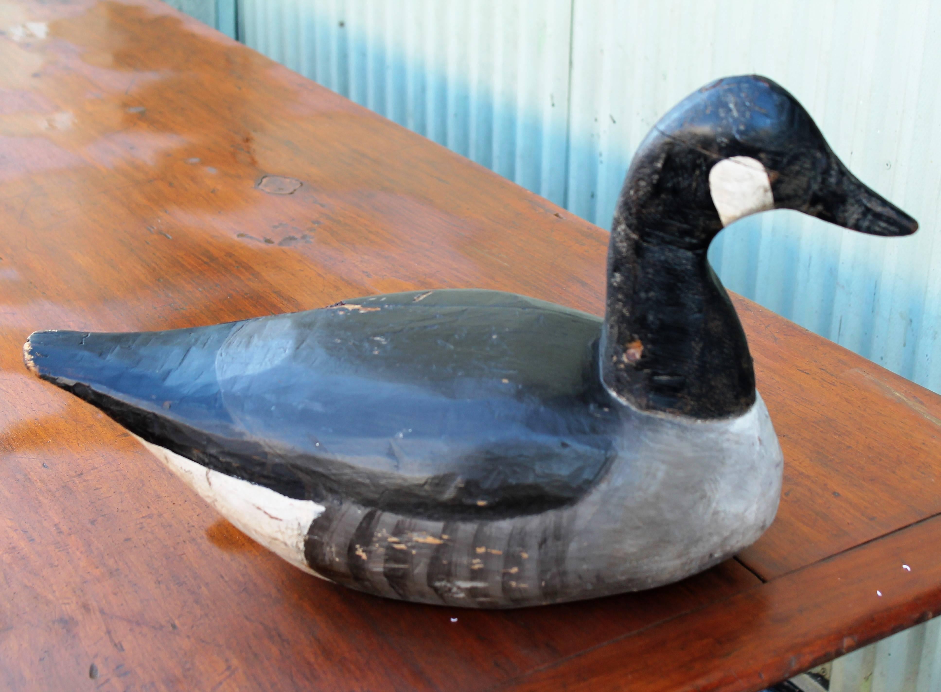 This large solid wood goose comes from the collection of Harry Walsh and was made by Doug Jester of Chincoteaque, Virgina and was purchased in Easton, Pennsylvania. Probably first quarter of the 20th century. All original painted surface with the