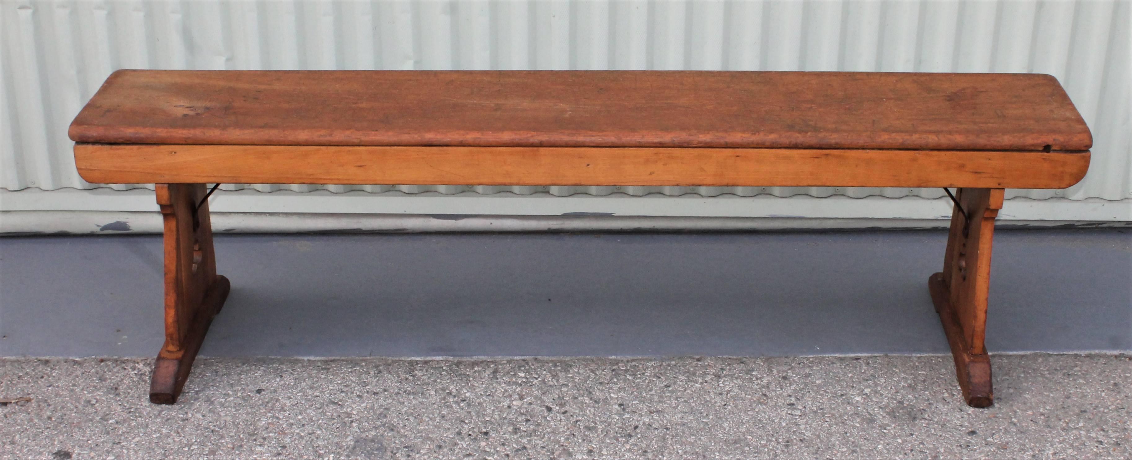 This sturdy pine bench has cut outs on both sides and thick shoe feet. This bench looks great on all sides. Would also be great to use at a farm table.