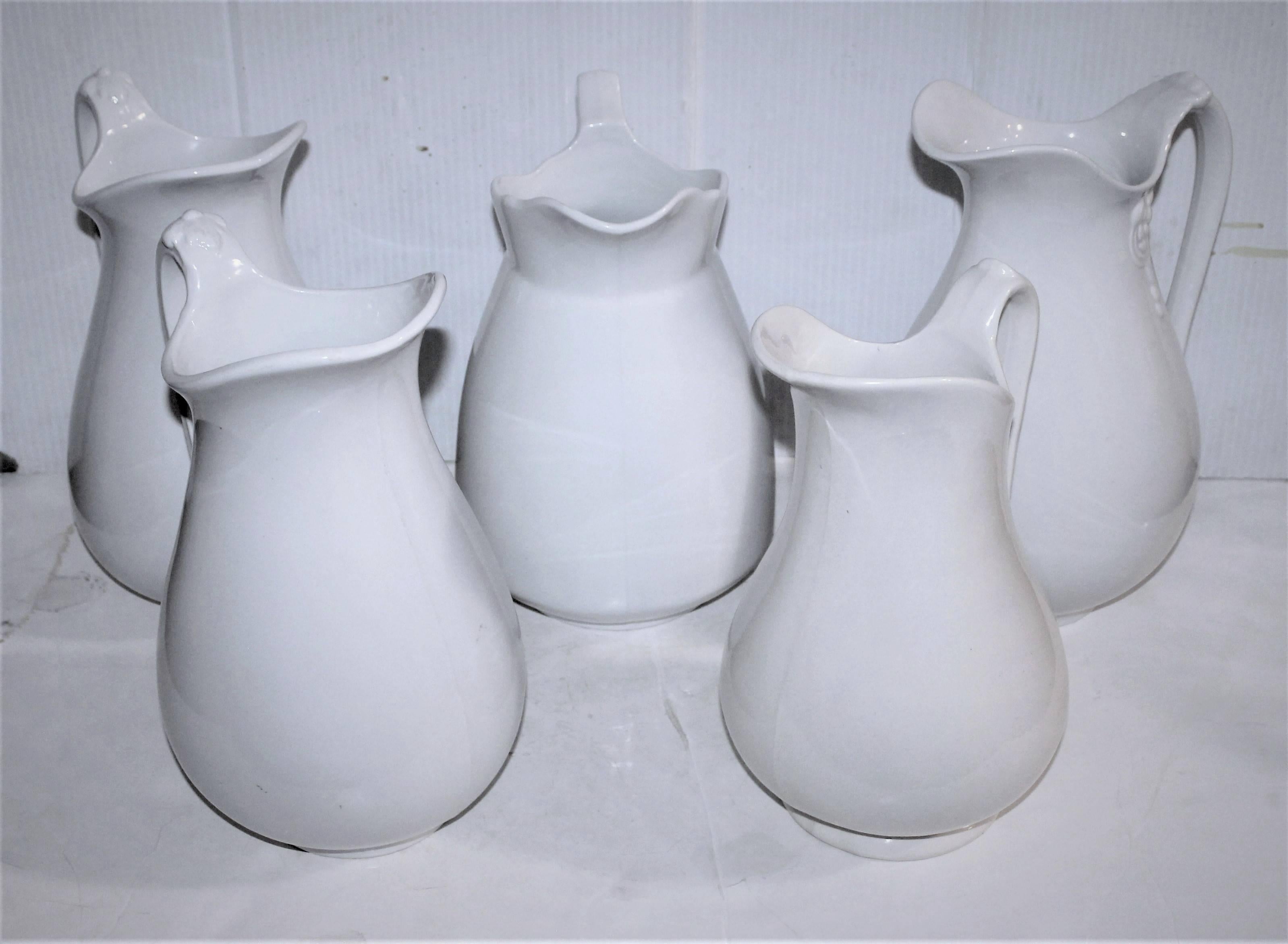 Wonderful collection of five mint condition English ironstone pitchers. Each pitcher is individually marked by the maker. This assorted set of five pitchers have minor wear consistent with age and use.