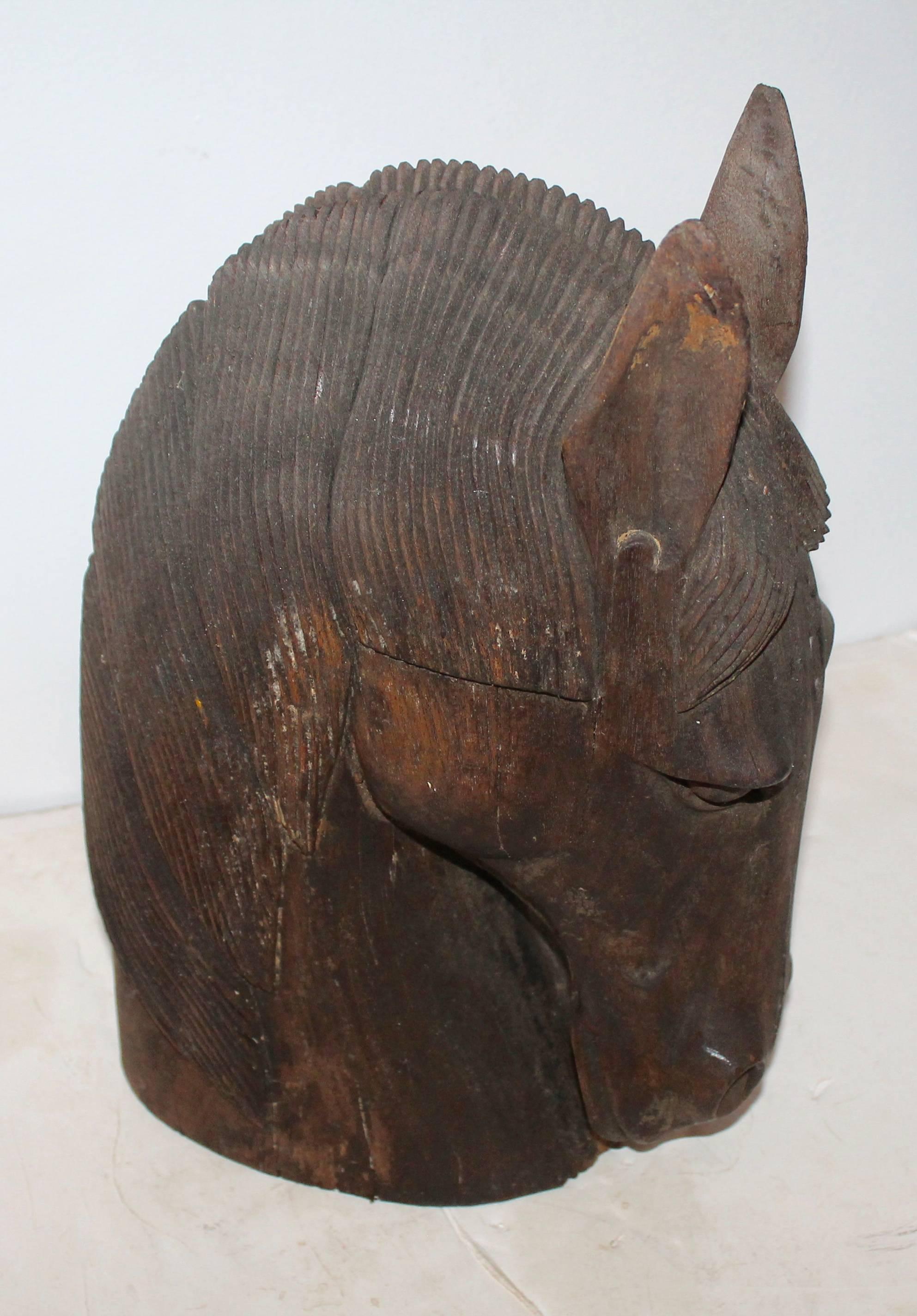 This fantastic hand-carved horse head statue is very well carved and in good condition. A couple age cracks consistent with age and use.