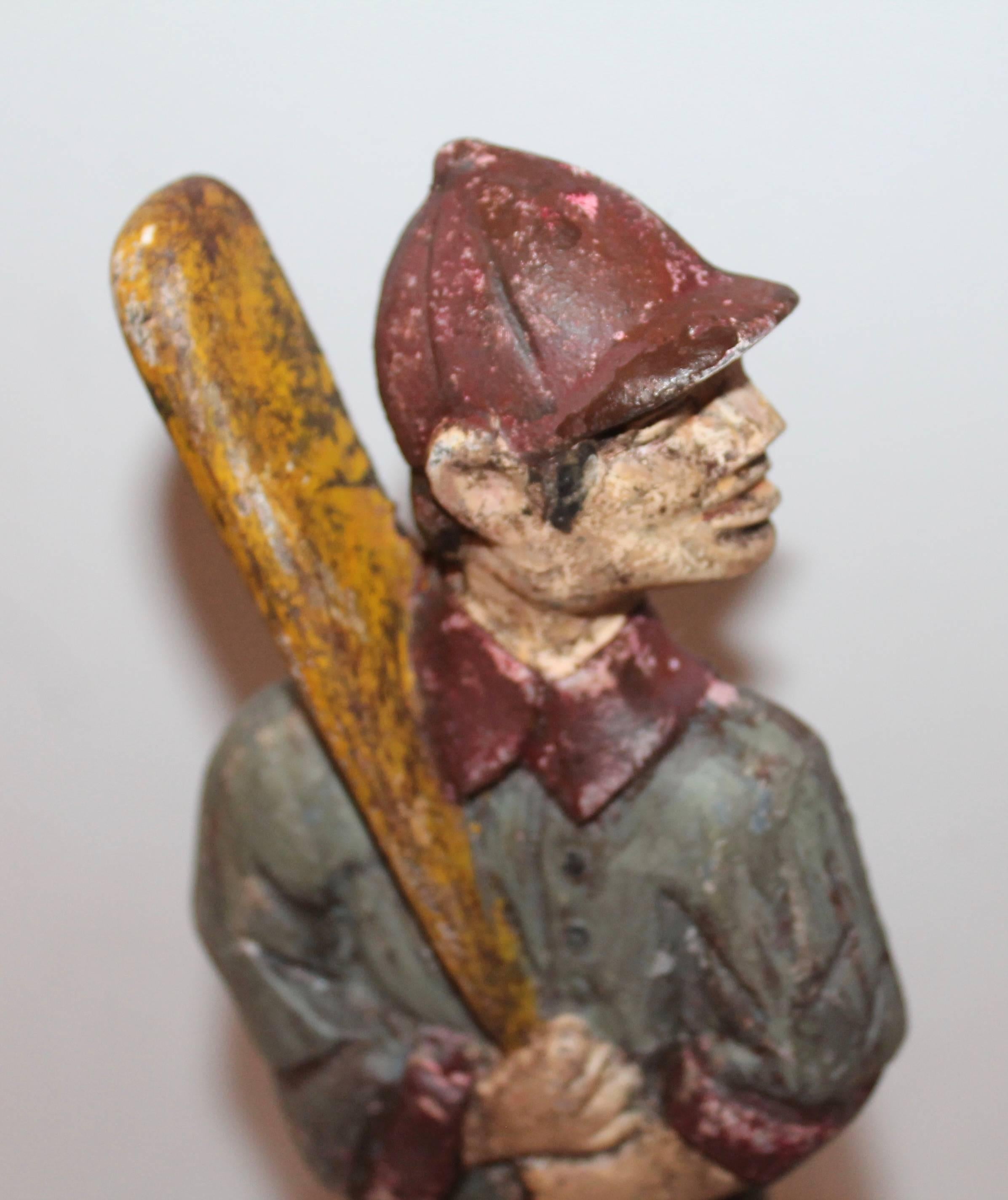This cast iron doorstop has been painted with several coats of paint and great form. Great looking for a boys room. It is over painted. Slightly worn painted surface.