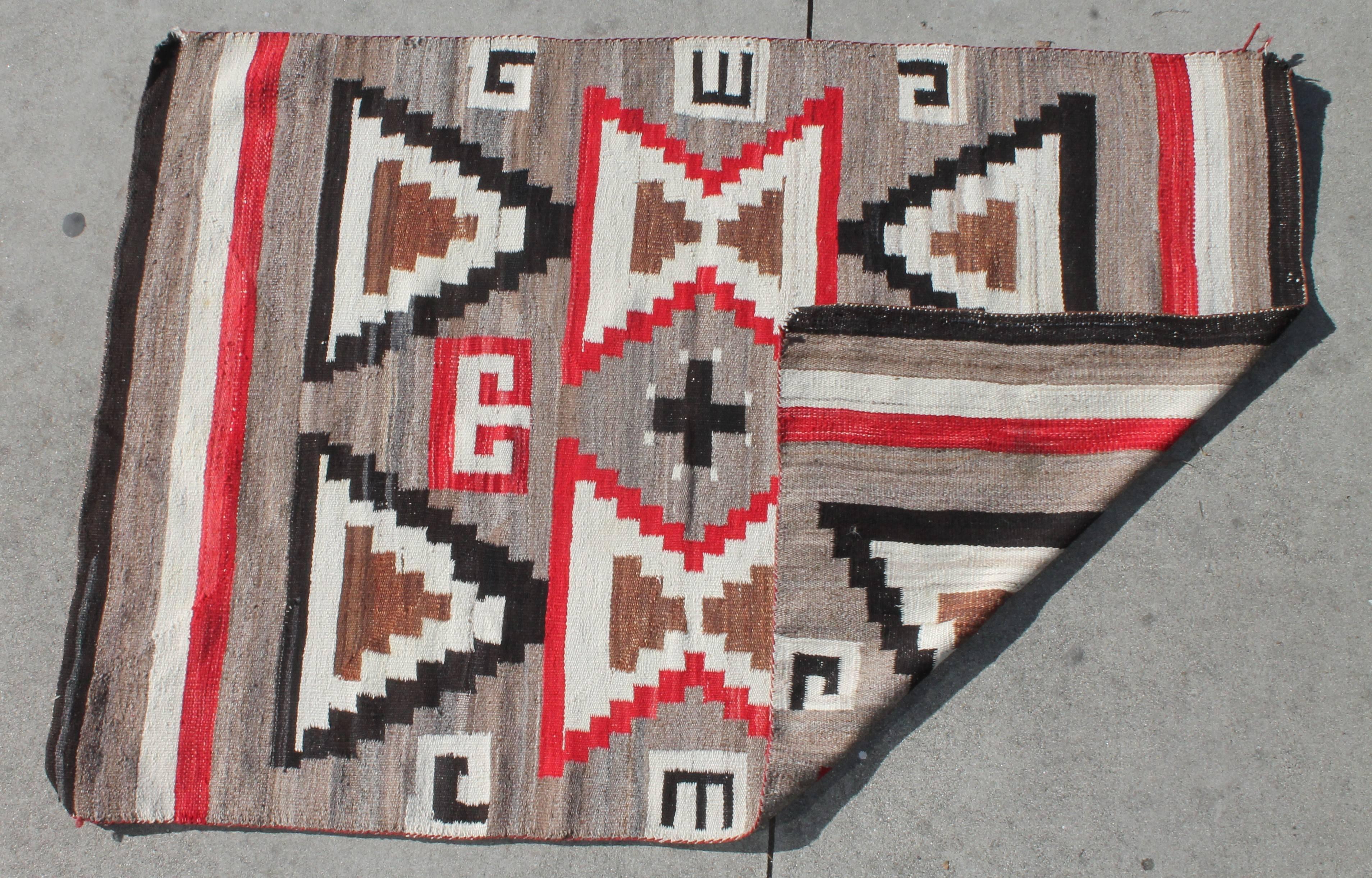 Navajo Indian weaving in amazing condition. Inward large flying geese pattern with center cross. This item has wear consistent with age and use. Very tiny old repairs.