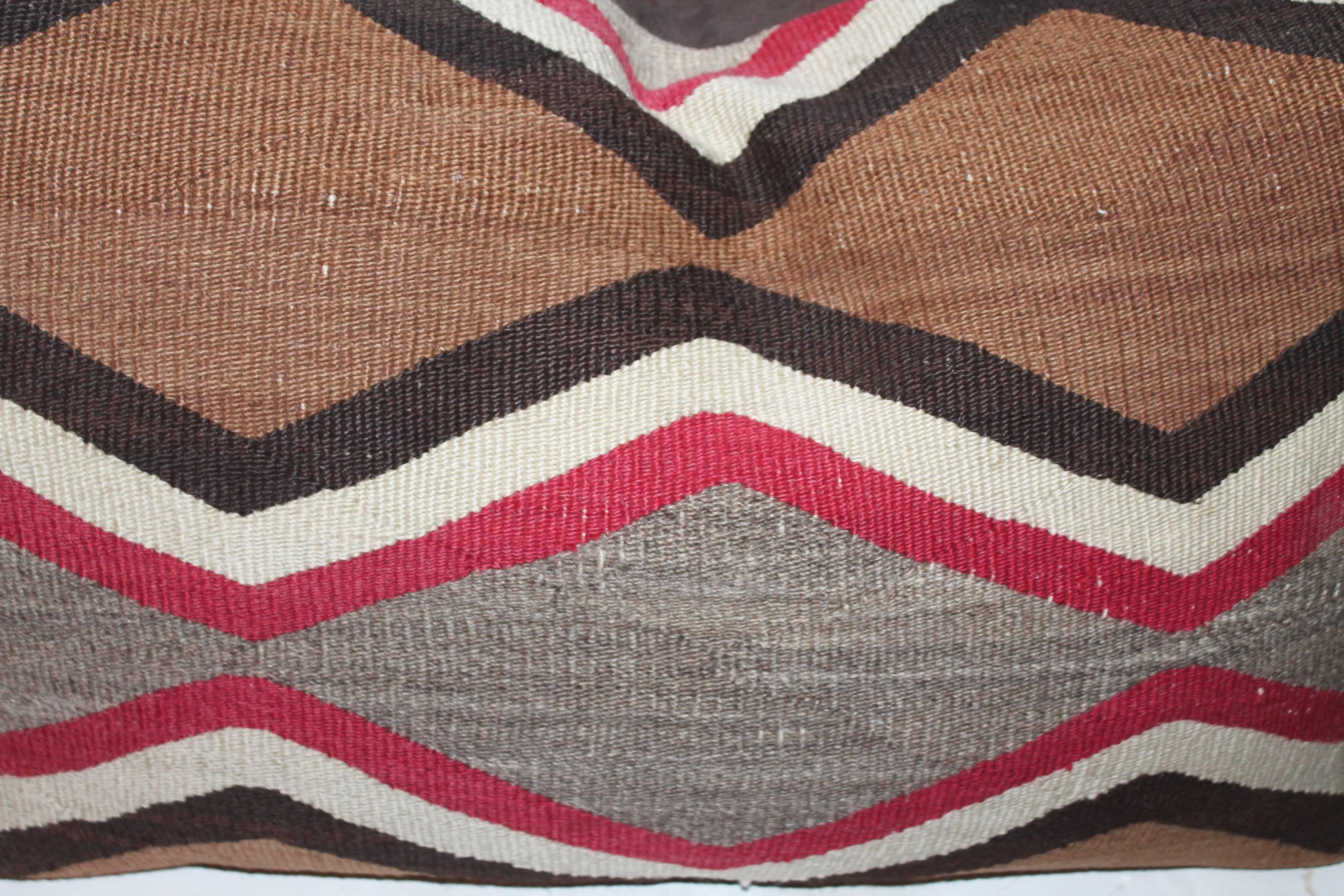 This pair of early large bolster pillows from an early Navajo 19th century transitional saddle blanket. The backing is in brown cotton linen. These are amazing and quite a rare weaving.