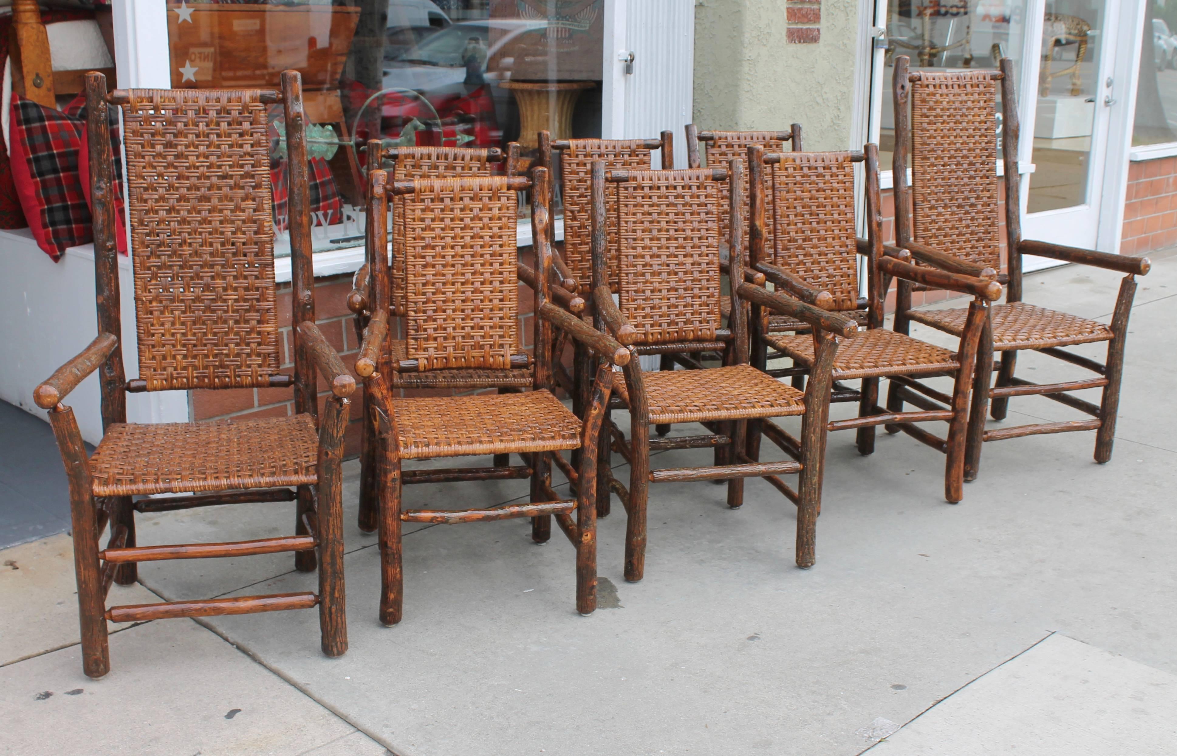 This fine collection of six regular dining chairs and two high back chairs are in fantastic condition. The handwoven caned seats and backs are in good condition as well. It is very rare to find a matching set and have the two head of table chairs.