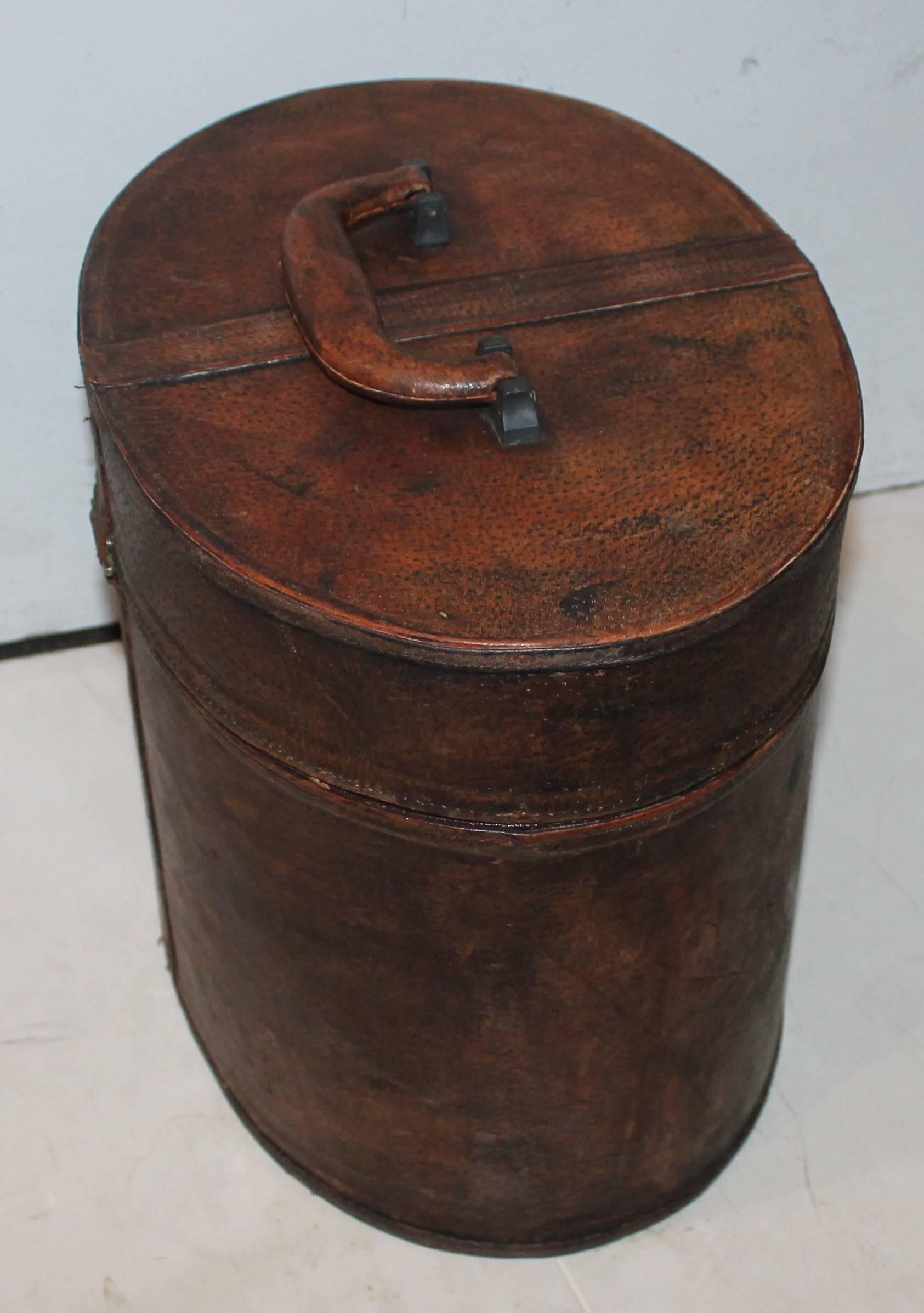 This large leather hat box is in great condition. Minor wear and scratches consistent with age and use.