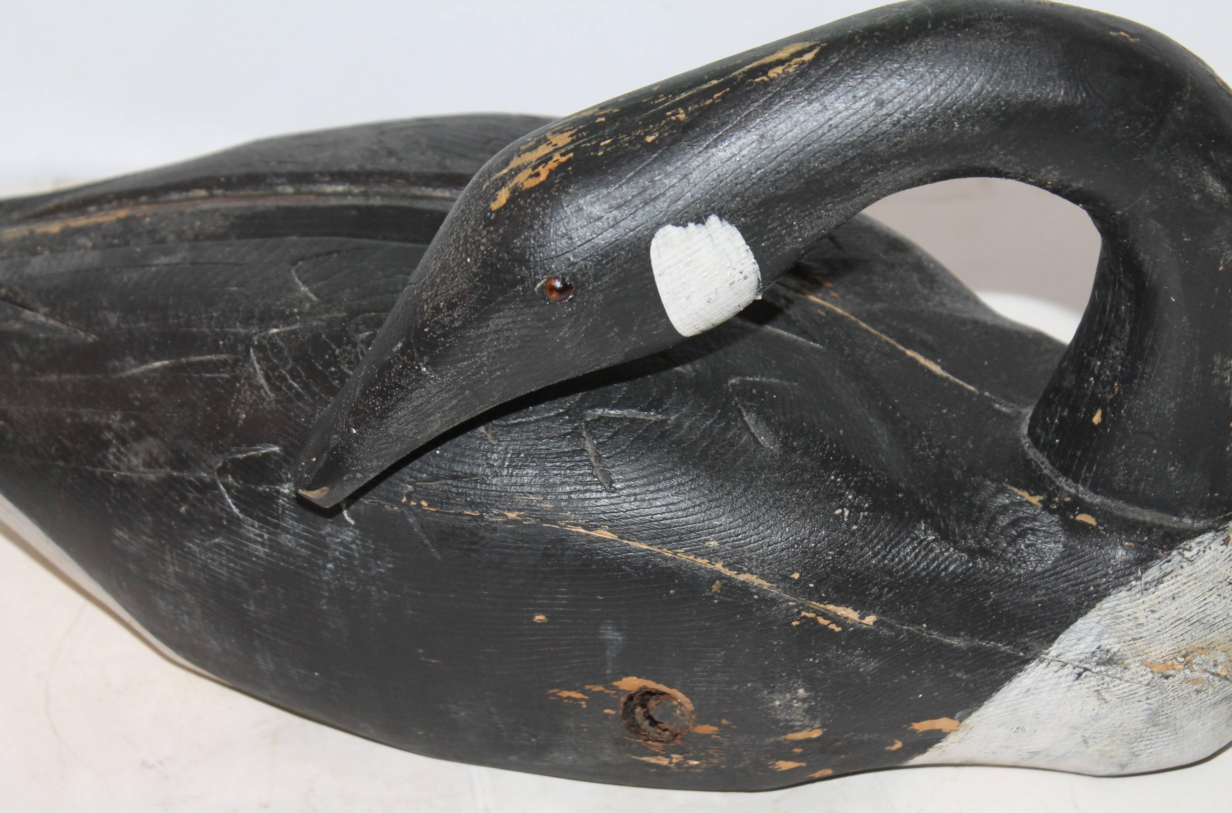 This beautiful Canadian goose decoy is in great condition. This Goose has original paint and great patina. The bottom of the goose where the weight and anchor once were shows the wear of the original wood over time. This goose is in all around great