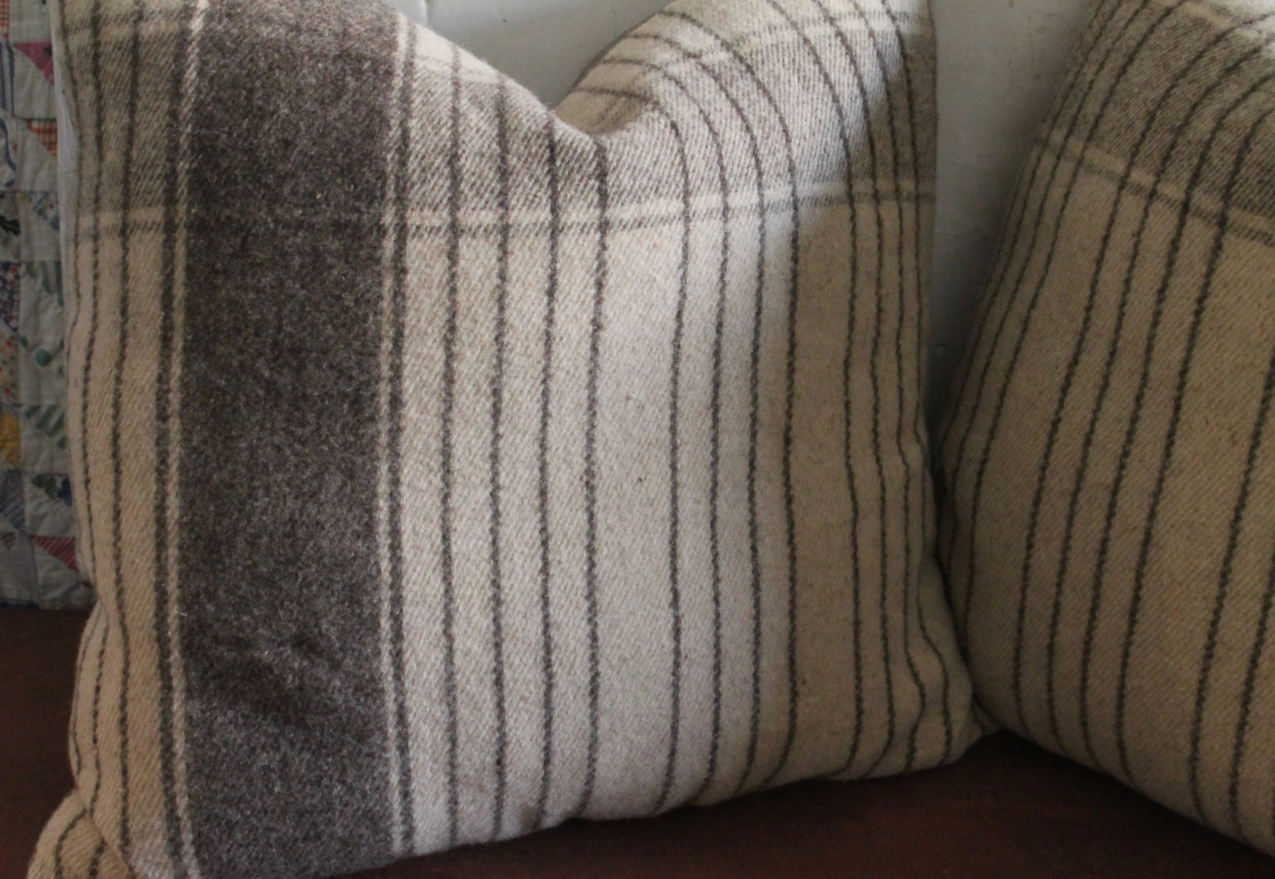 These soft woolen weaving pillows are in fine condition and have a matching grey cotton linen backing.