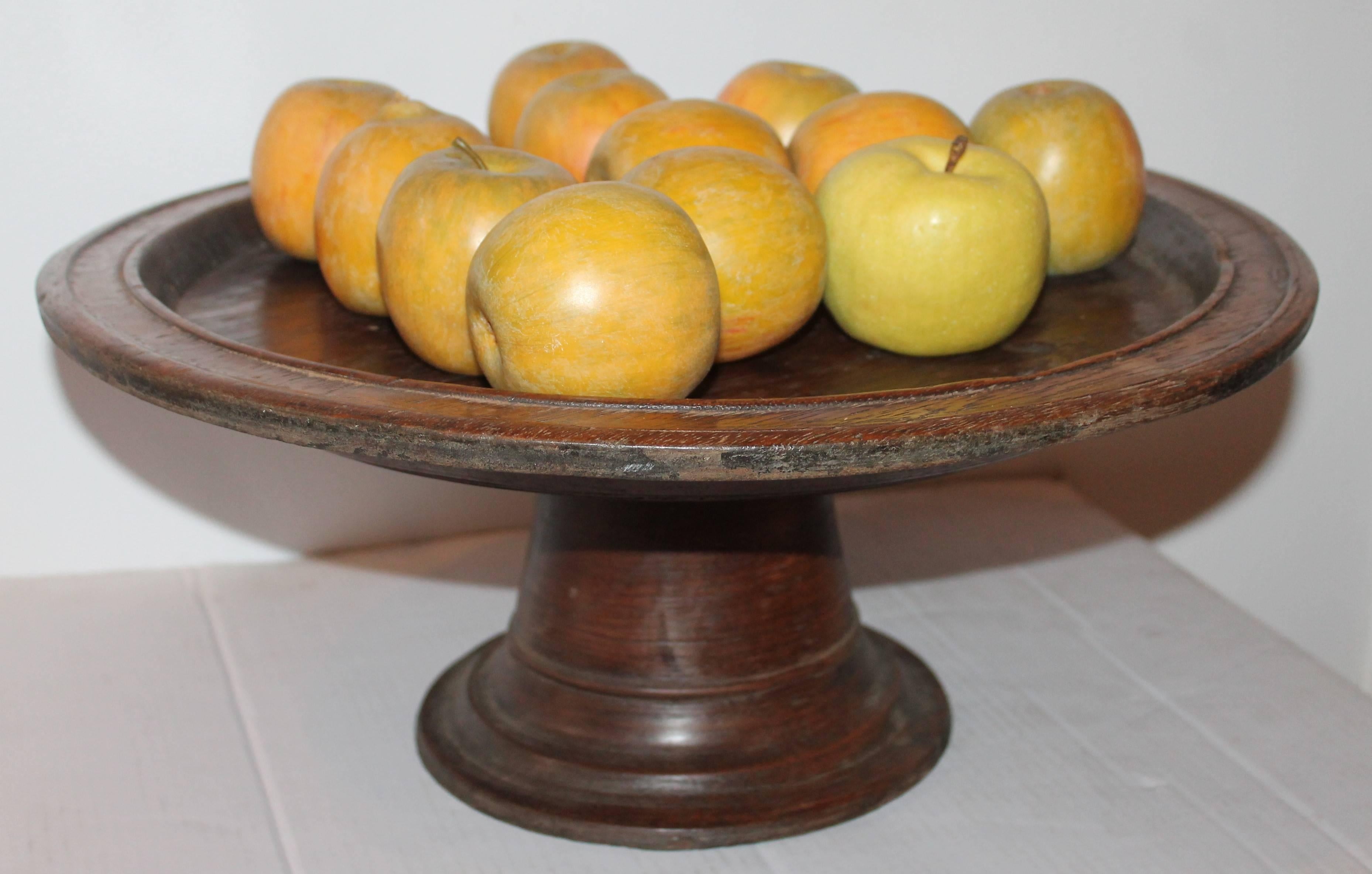 This early hand-carved 18th century wood trean pedestal has a wonderful aged patina. The condition is very good with a minor hairline in top. It is in very sturdy condition.