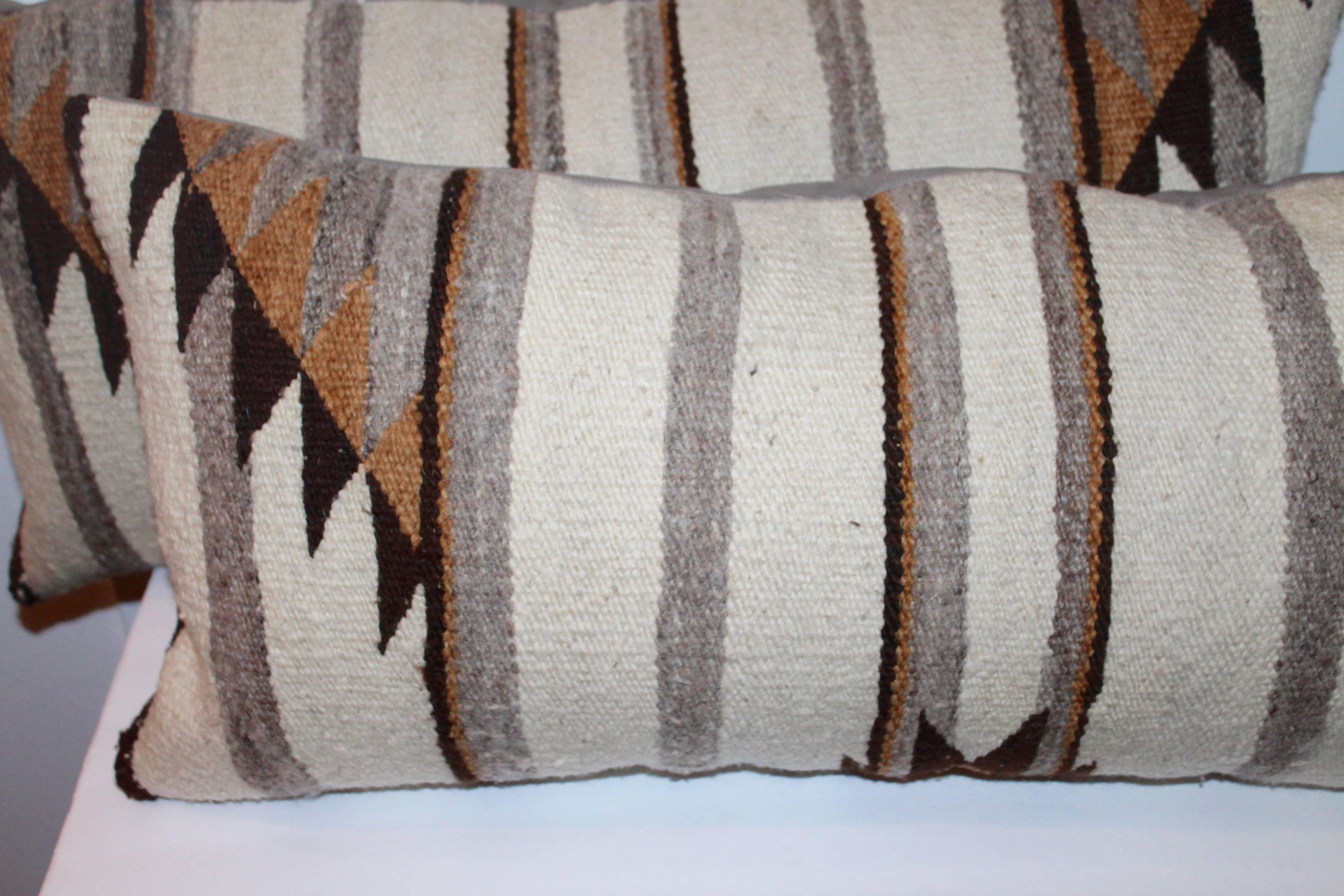 These geometric weaving bolsters are in fine condition and have taupe cotton backings. Sold as a pair.