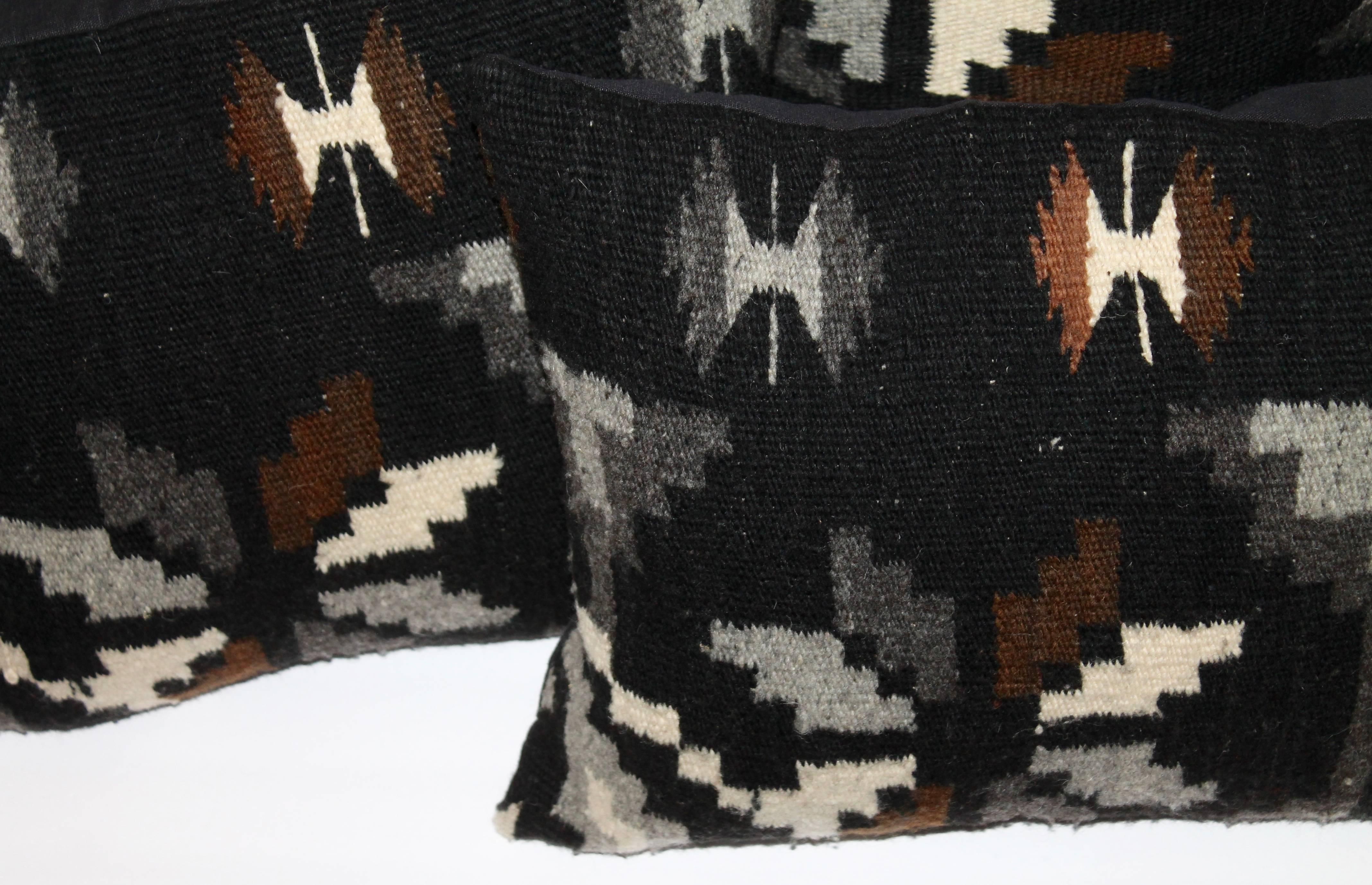 Two pairs of black Navajo weaving pillows with black cotton linen backings. These are quite unusual in black with other shots of colors. All in great condition.