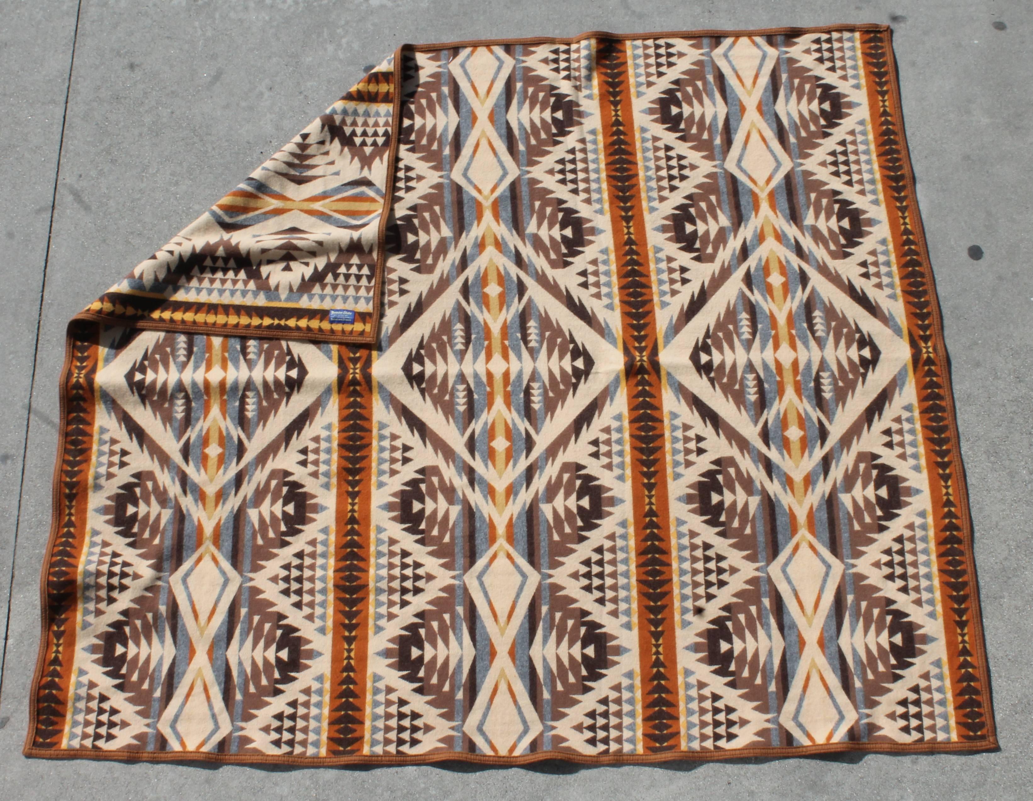 This fine wool Indian design camp blanket has the original label on the blanket. It is in fine as found condition. This blanket has the original wool binding on it.