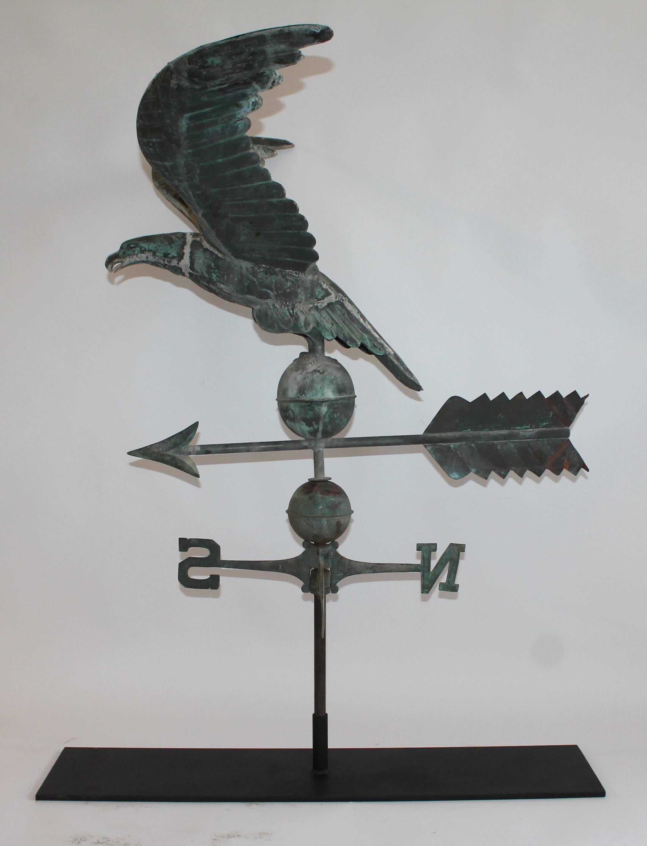 19th century monumental full body copper eagle weather vane in good condition. The patina surface is great and the base has the original Directional siting on a large custom-made iron stand or mount. This eagle was found in New England. Can be
