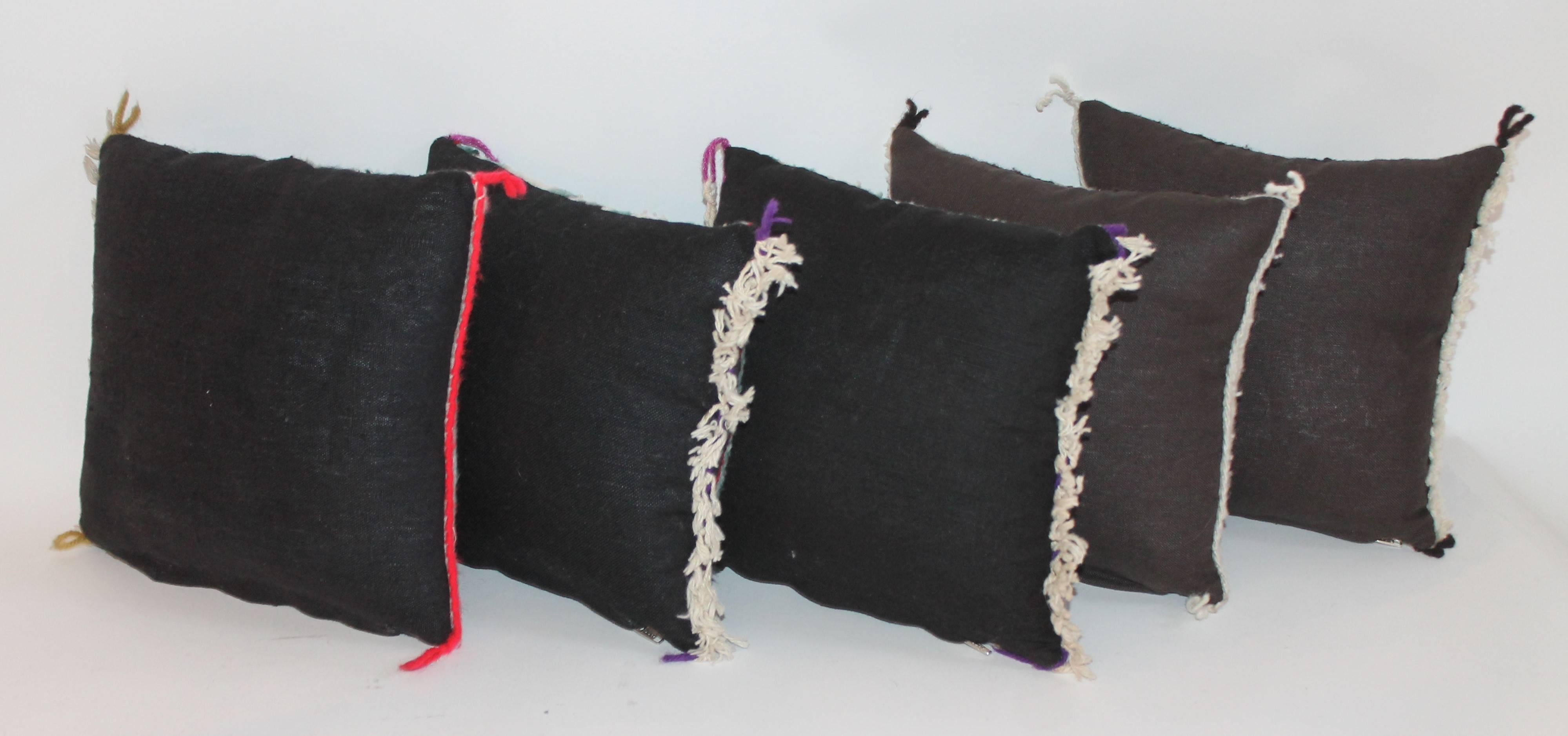 These miniature Navajo Indian weaving pillows. There are two matching pairs and one odd pattern single.

Dimensions are from left to right:
10.5