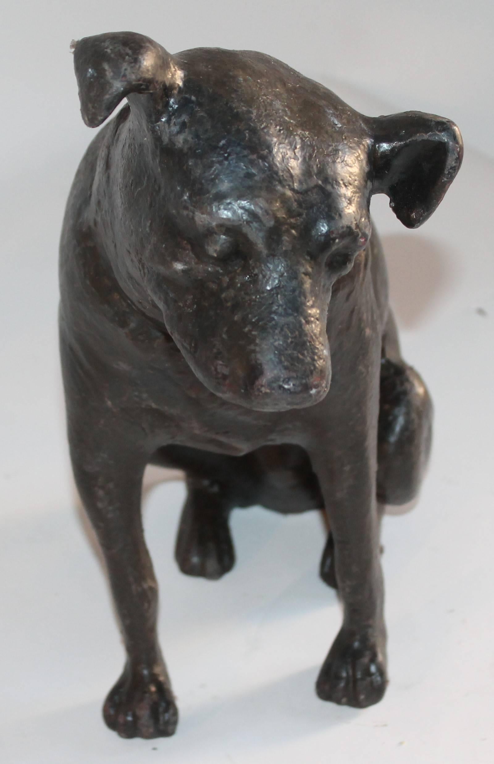 This black painted cast iron dog sculpture is in amazing condition and is a very heavy piece of art. Yes it could be used as a huge door stop. The form is fantastic along with it looking so realist.