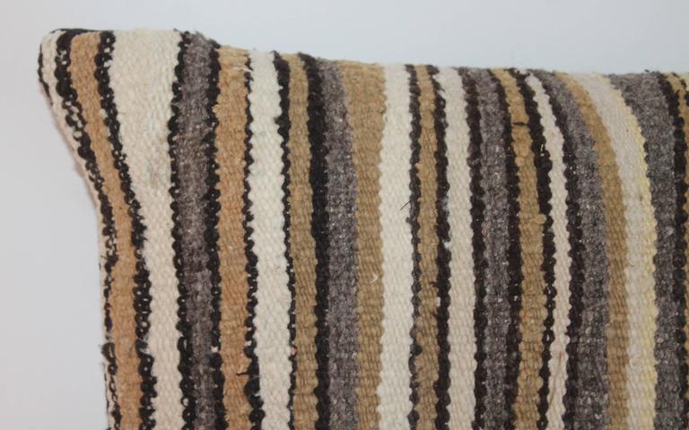This is quite interesting for a Indian weaving bolster pillow. Stripes in neutral colors and great condition.