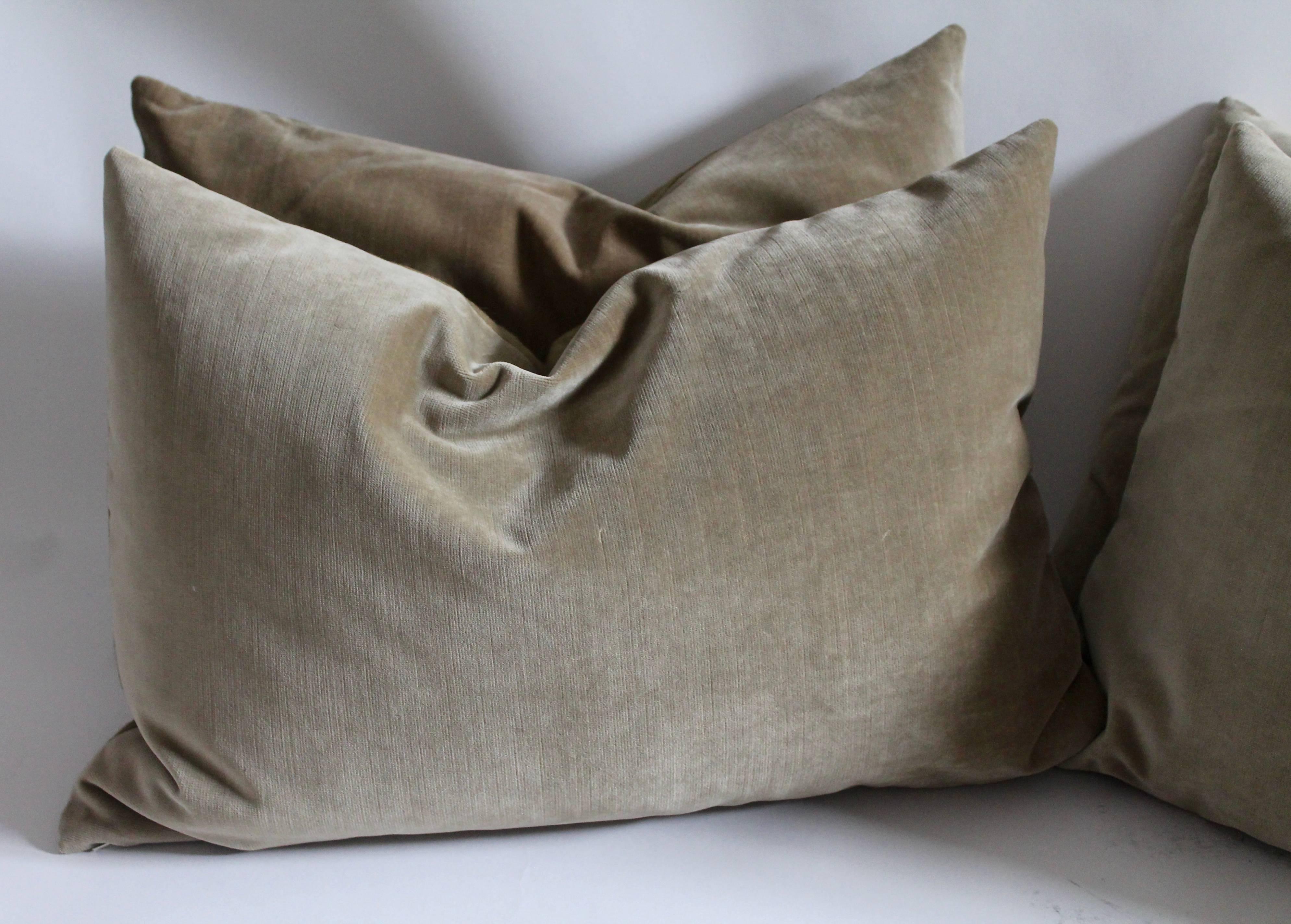 These bolster or kidney pillows in a soft khaki vintage velvet have a warm khaki tan linen backing. The inserts are down and feather fill. Sold as a group of four.