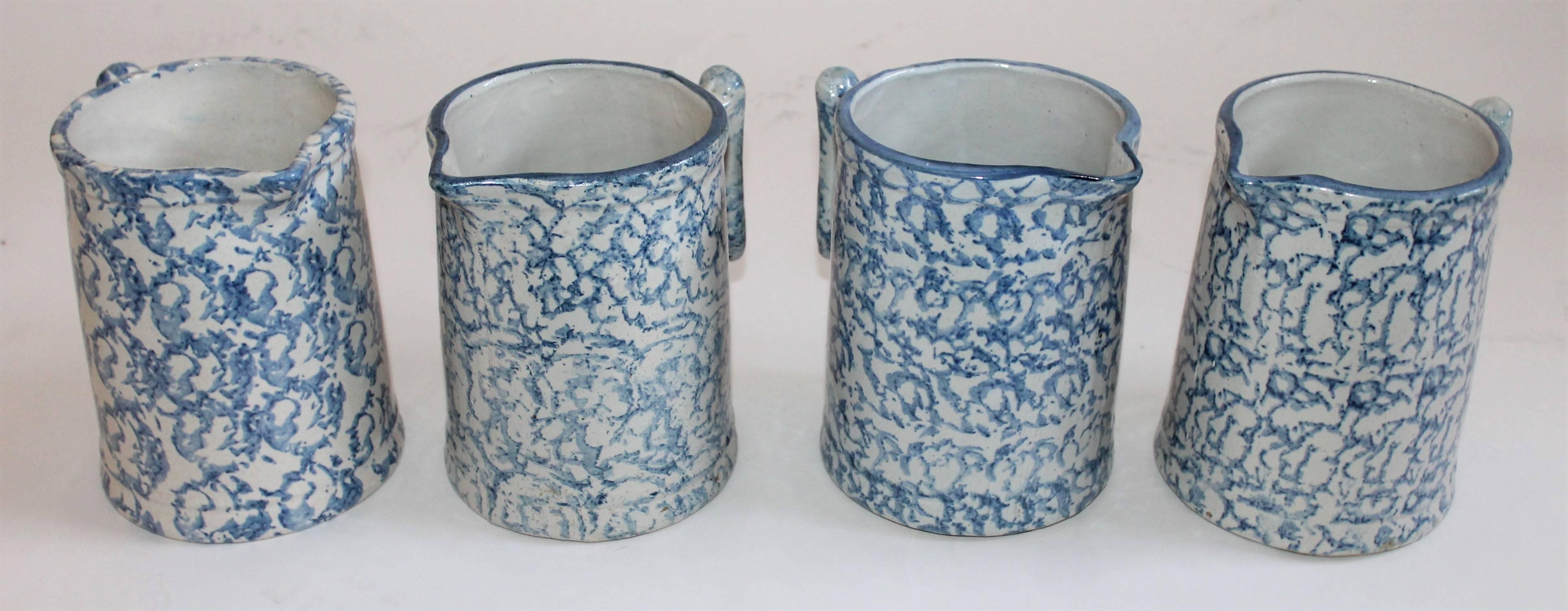 Collection of four pristine condition 19th century sponge ware milk pitchers. This is such a fine group of pottery pitchers in great light blue colors.