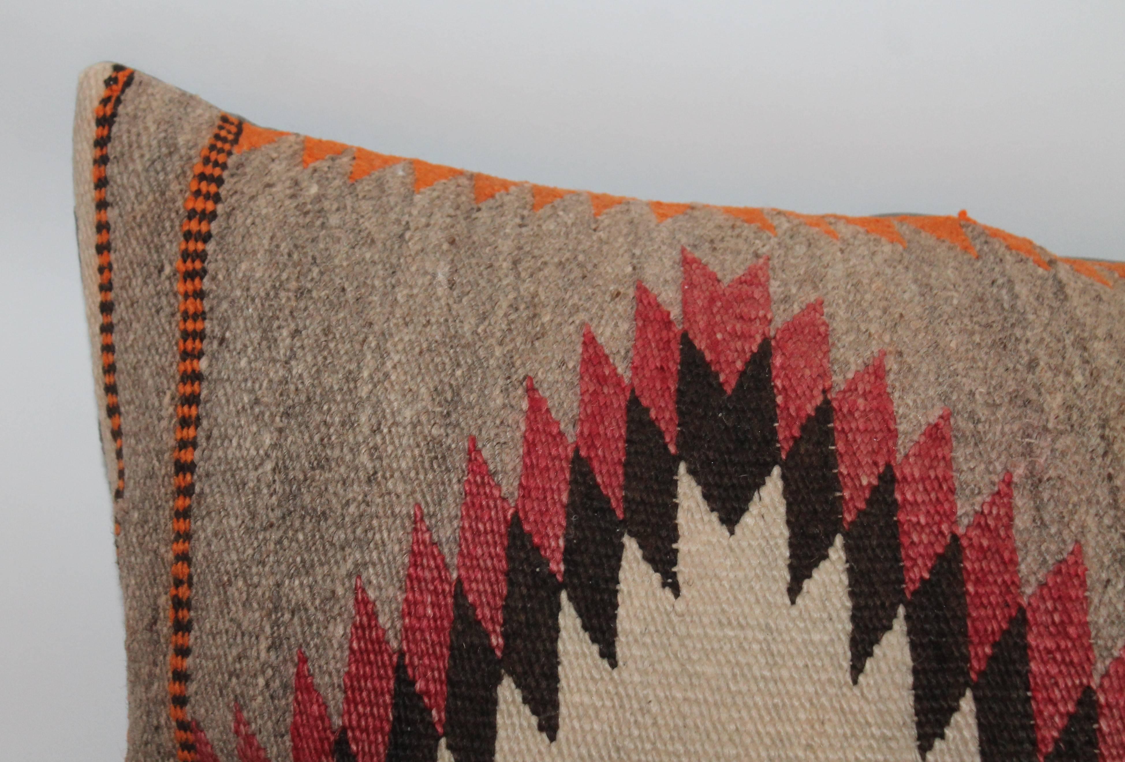 This large Navajo weaving is in fine condition and has a wonderful overall muted or faded look. The backing is in a taupe cotton linen. Great on a large sofa or queen or king bed. This is a large saddle blanket and has not been cut.