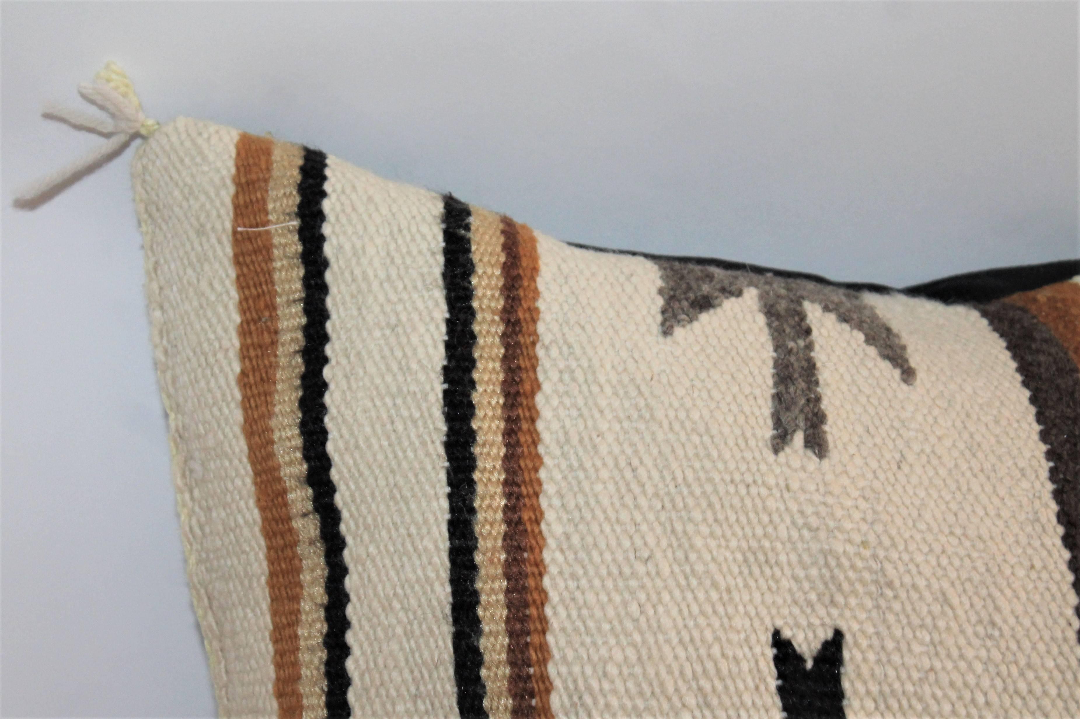This most unusual cream back round Navajo saddle blanket weaving is in fine condition and has a black cotton linen backing.