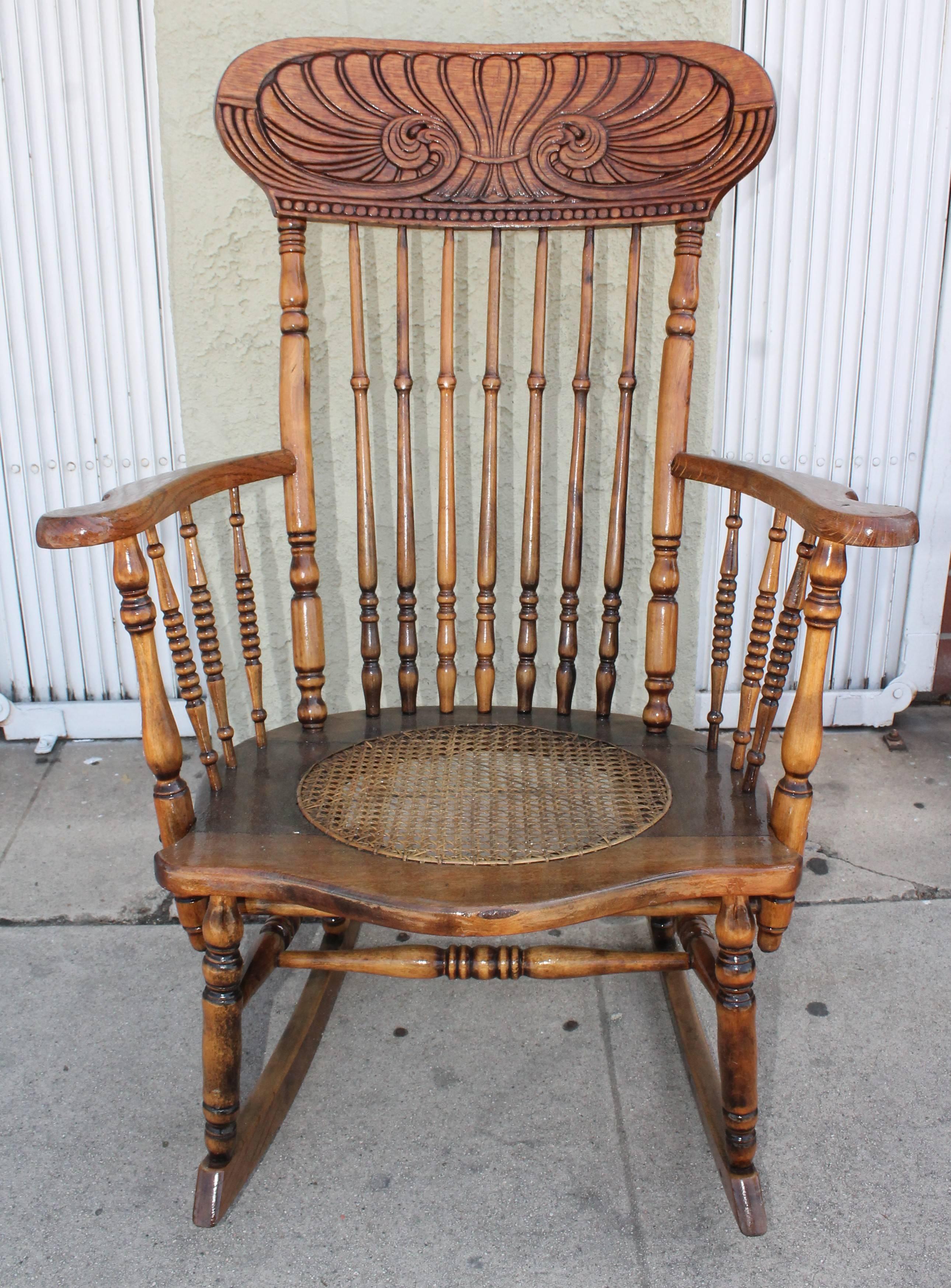 old rocking chair with hole in seat