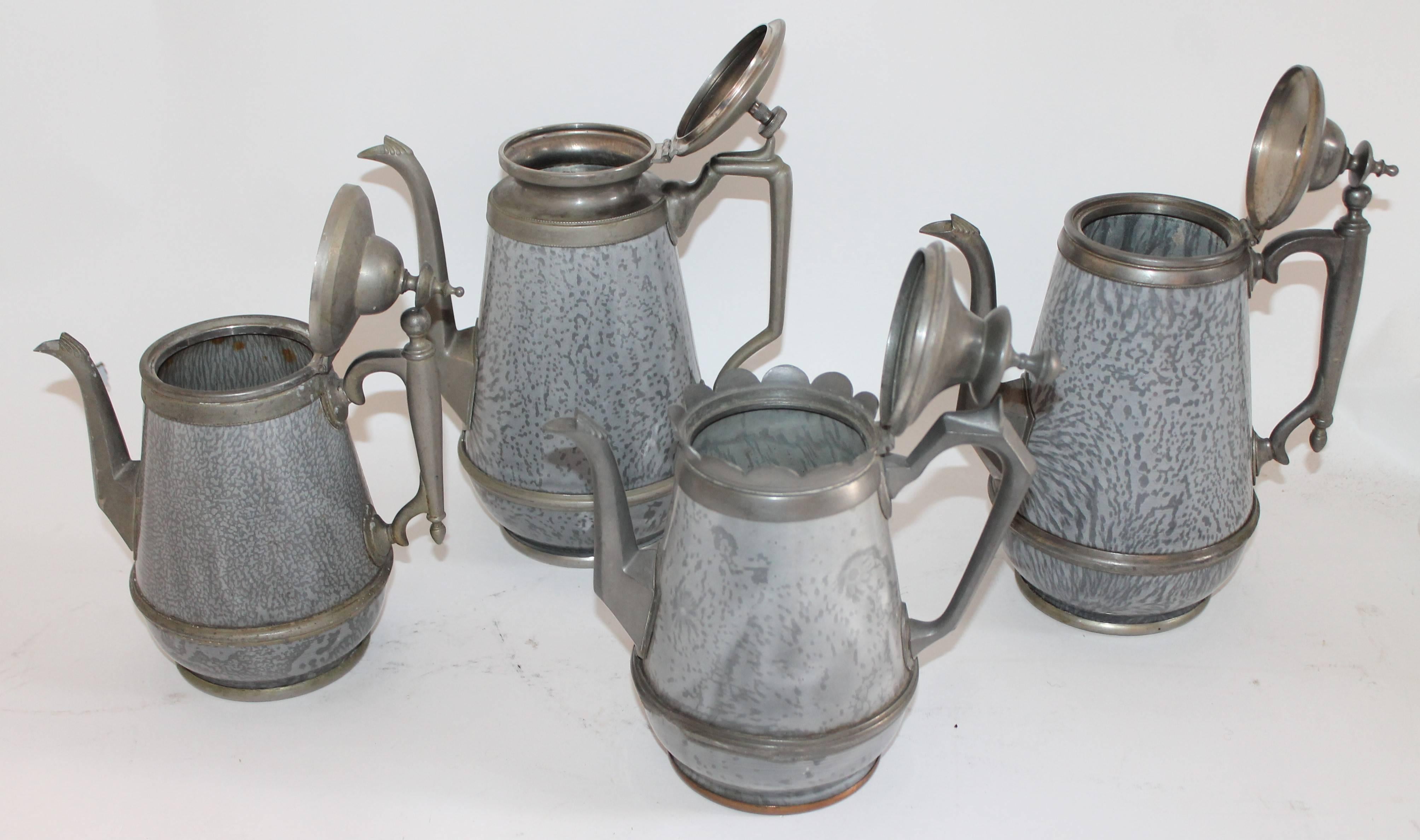 This fine collection of enamel coffee pots are in pristine condition and come from one collection. The mix of pewter and enamel looks great with any collection of antique pewter serving pieces. One is dated 1818. Minor dents in some areas of the