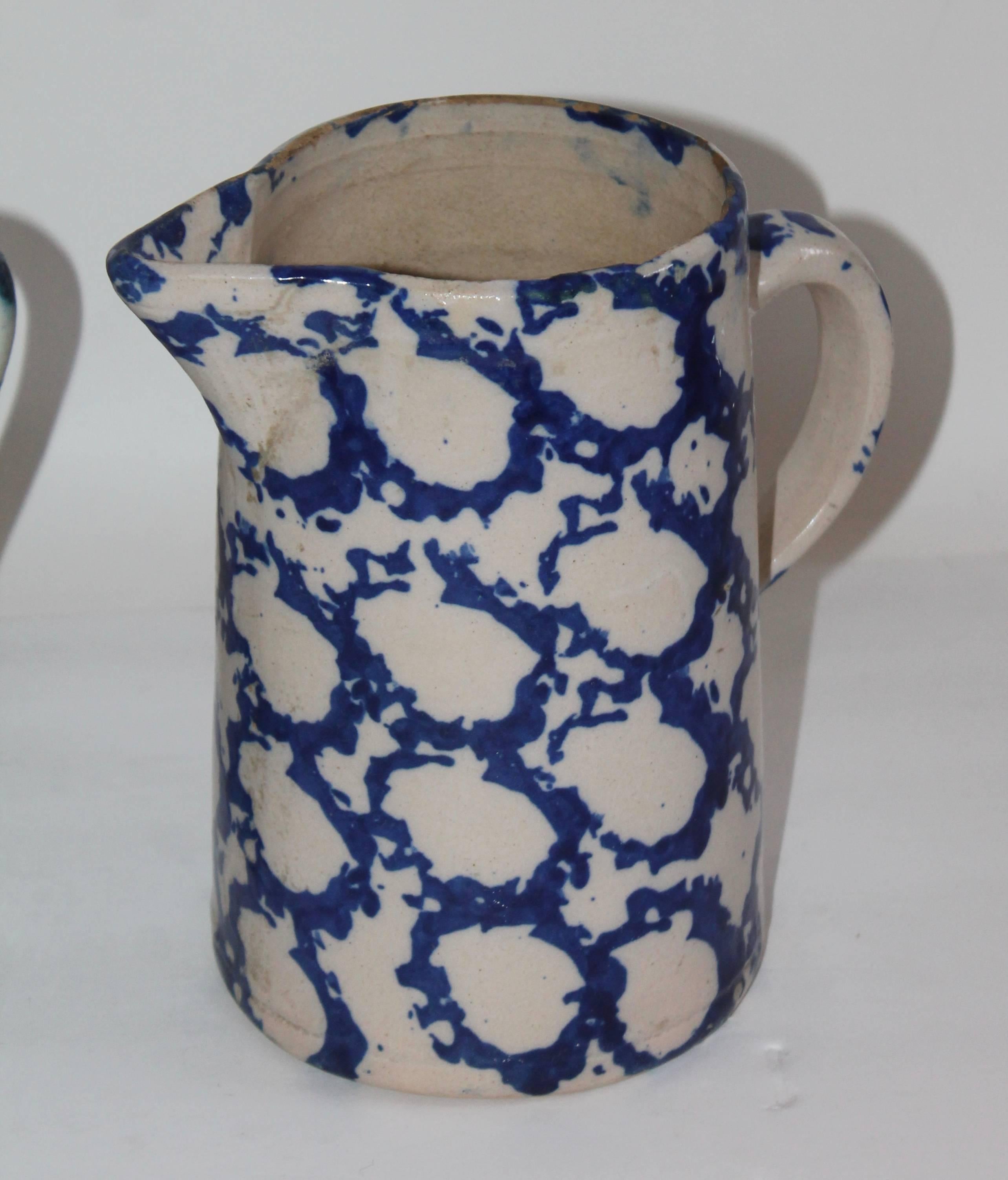 These tall patterned spongeware pitchers are in good condition with minor wear on the one pitcher to left its spout has warn down on the top. It does not detract from it's beauty. Sold as a group.