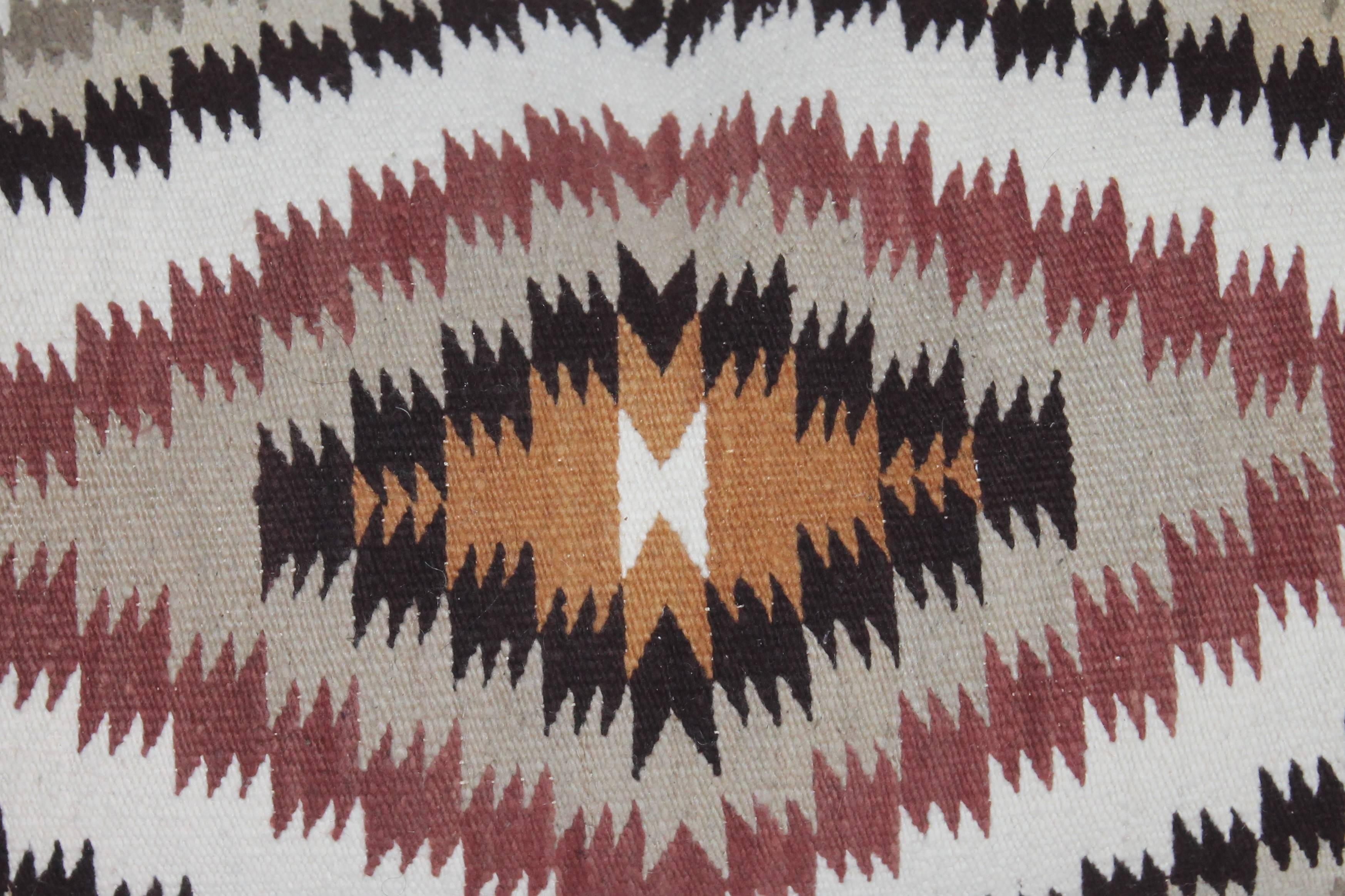 This fine Navajo Indian weaving pillow is in great condition. This saddle blanket pillow has a taupe cotton linen backing. Down and feather fill.