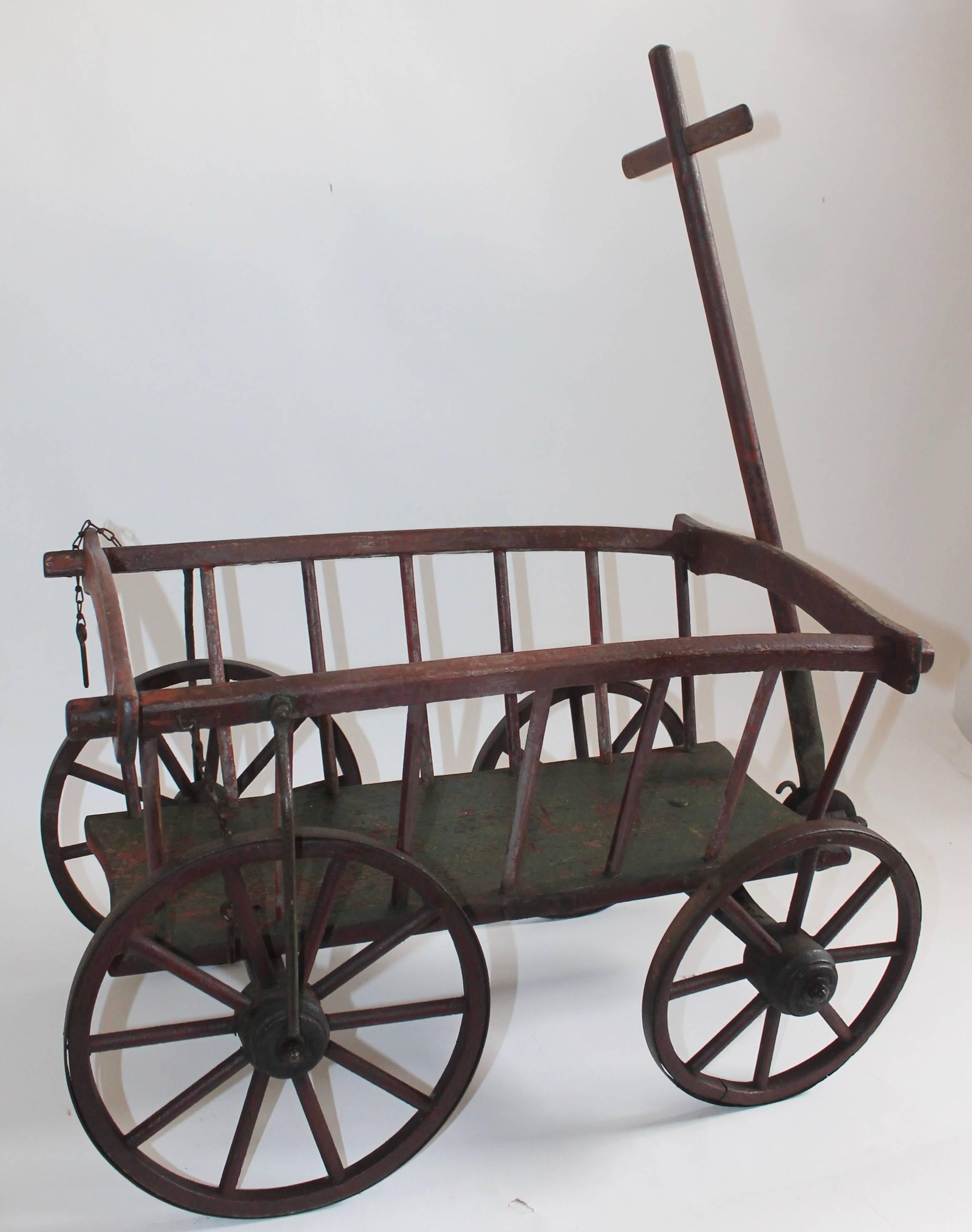 This great example of a handmade European child wagon is a testament to 19th century European Folk Art. This handmade wagon is all original and has its original parts. The hand-carved mark reads : NAETHER. This is truly a great item in amazing