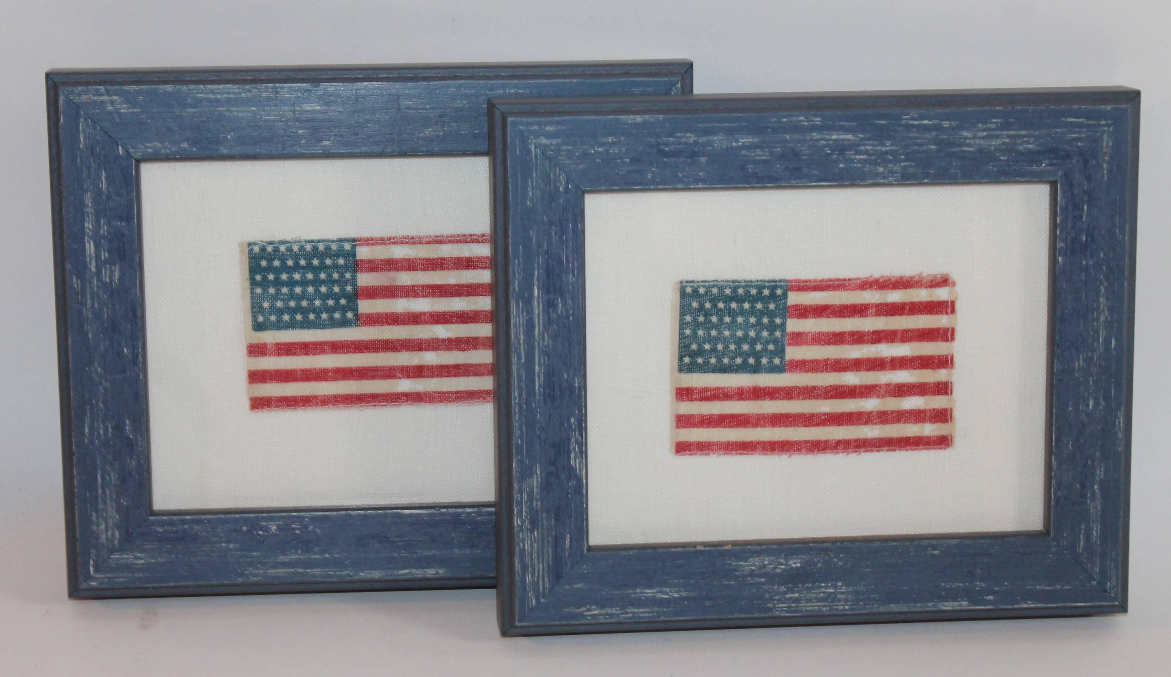 The distressed blue custom-made wood frames contain 46 star parade flags hand-sewn on cream cotton linen are sold as a pair. Great addition to any Americana collection.