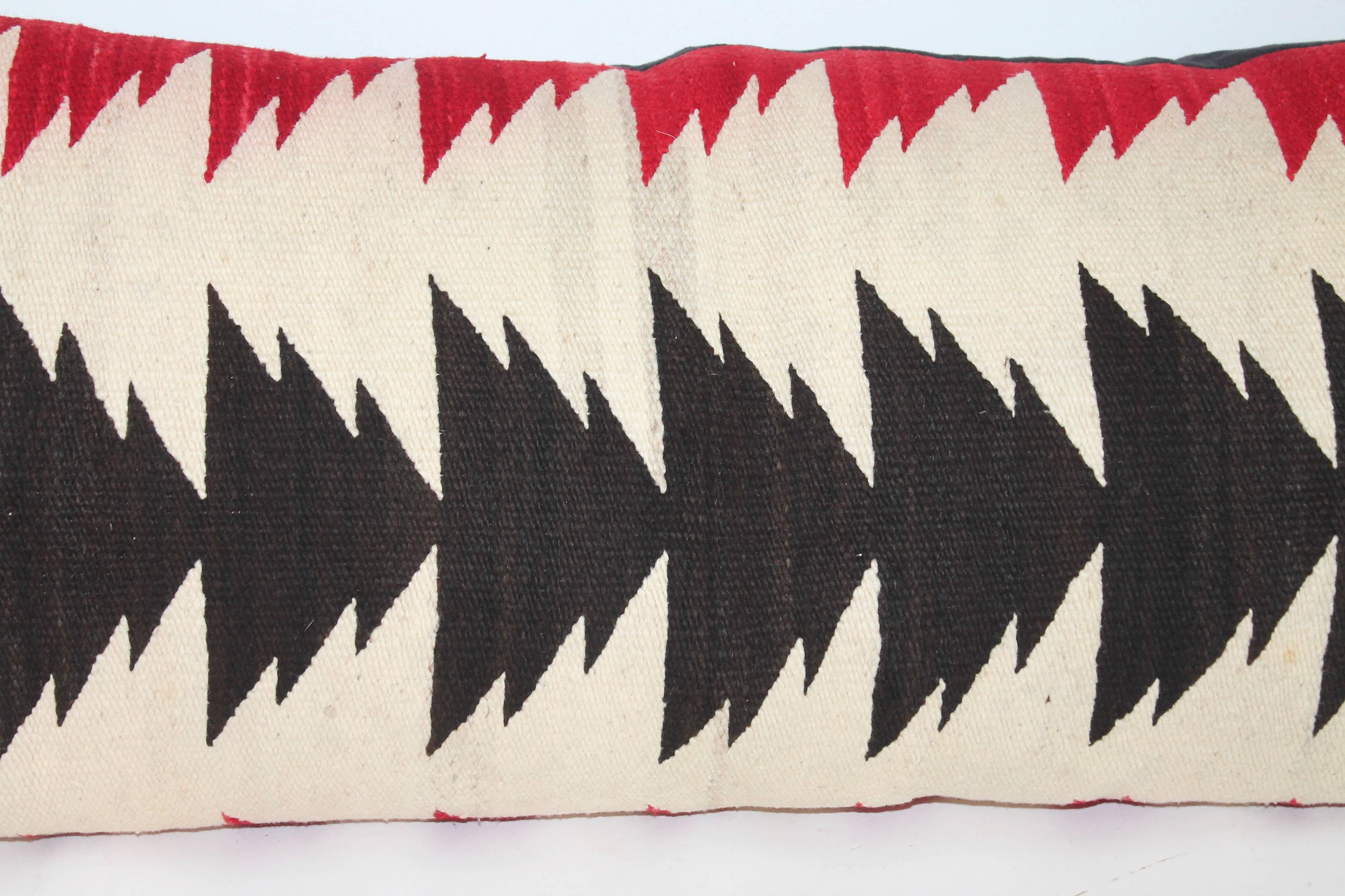 This cool arrows pattern Navajo weaving pillow is in red, black and a cream ground. The condition is very good with a black cotton linen backing. Down and feather fill. This weaving is so geometric and cool.