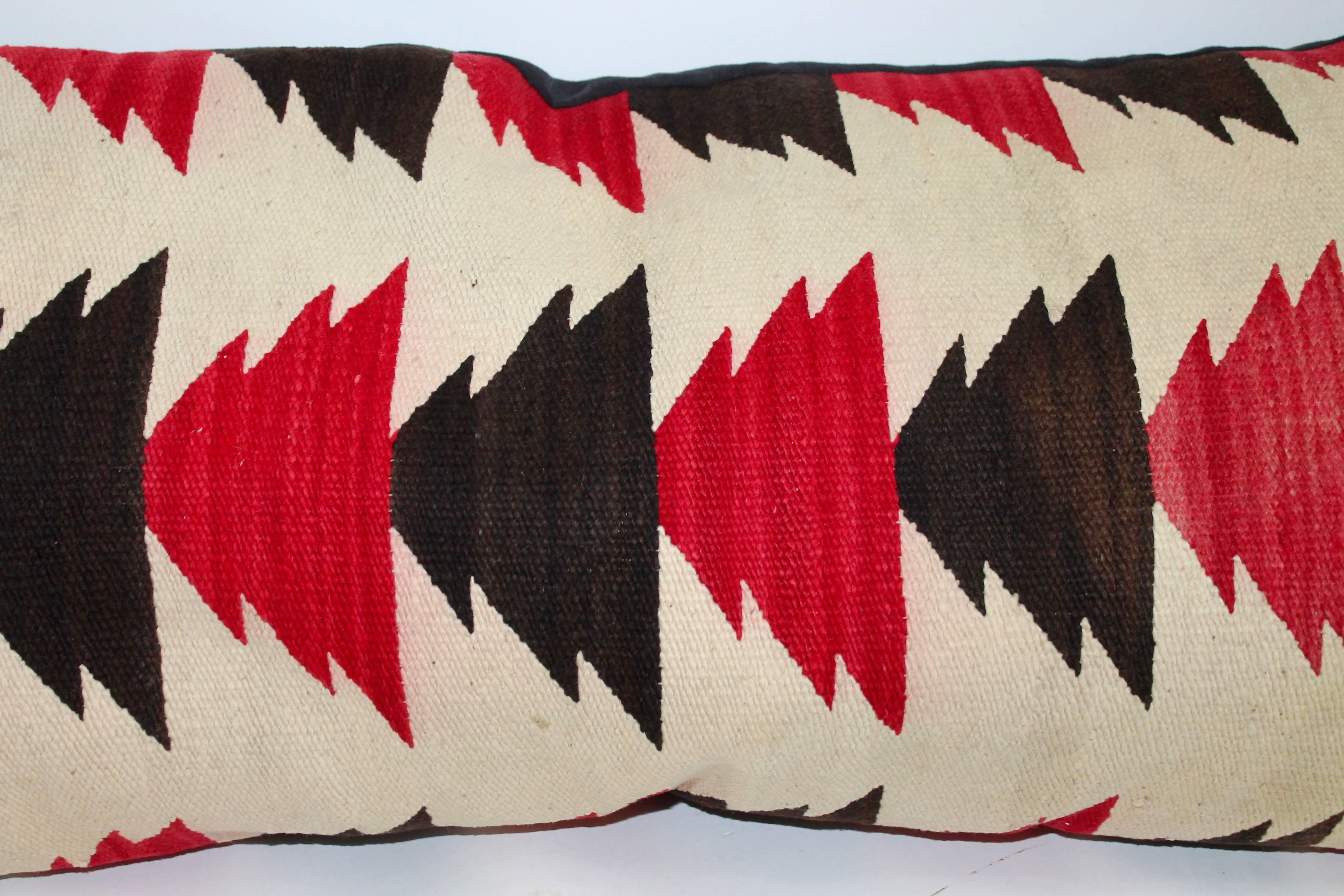 This fine and most unusual Navajo Indian weaving bolster pillow is in the arrow or flying geese pattern. The condition is very good and the backing is in black cotton linen.