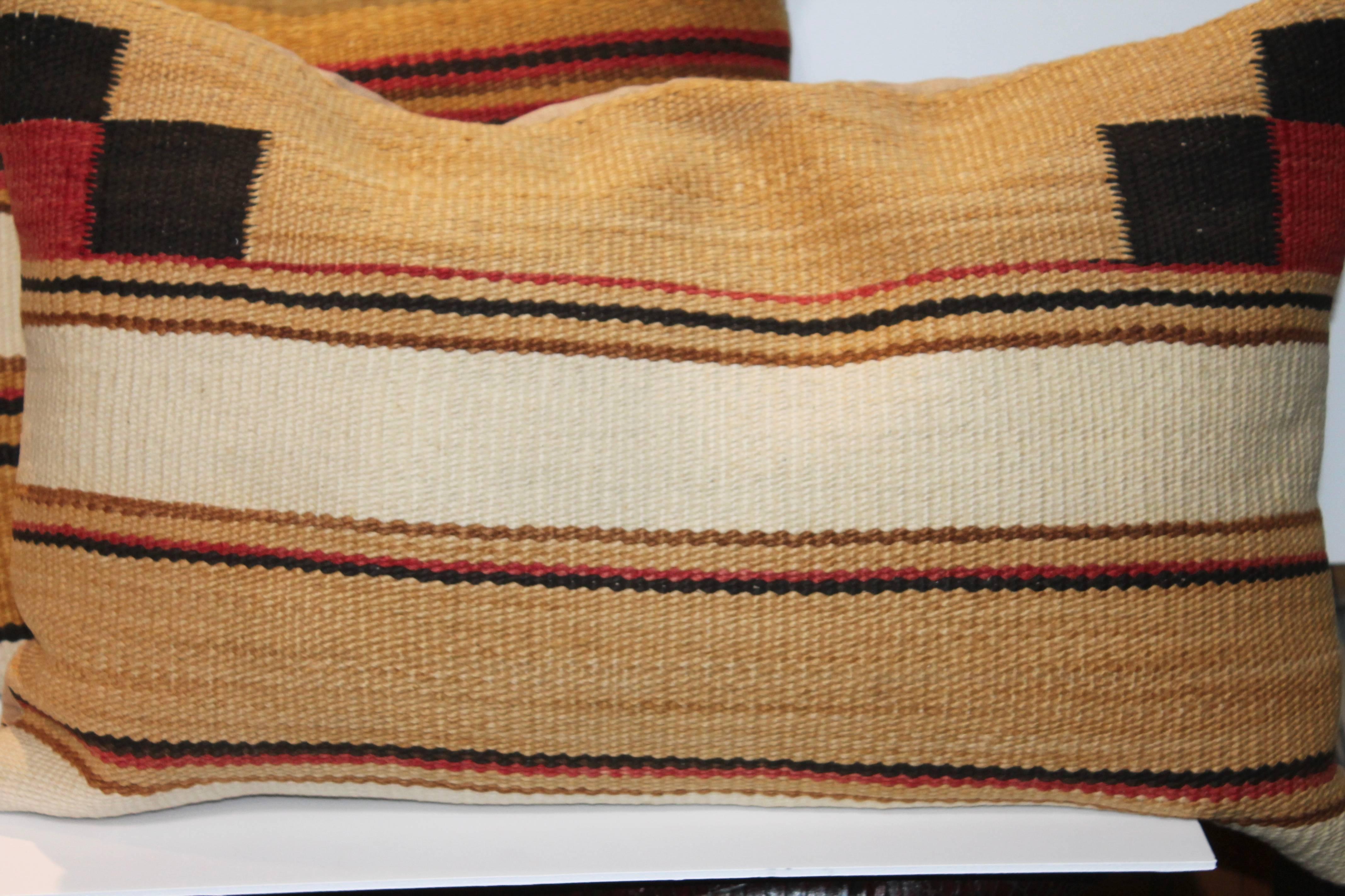 These fine country colors are in great as found condition and were from a saddle blanket weaving. There is a total of three pillows in stock. They would be sold as a pair.