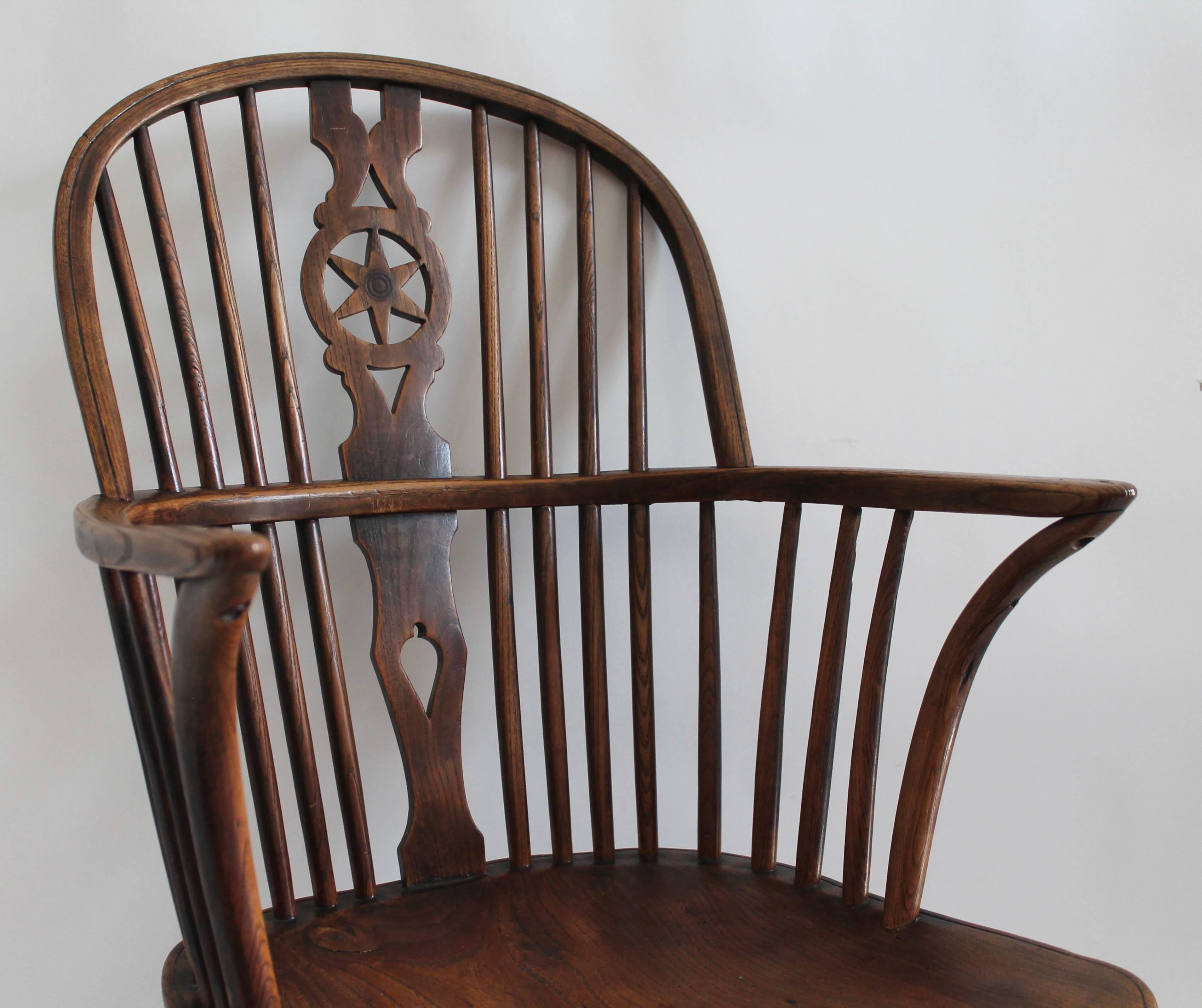 Early 19th century amazing Windsor chair with star cut-out on back splash of chair. This extended arm Windsor chair is very comfortable and has a amazing patina.