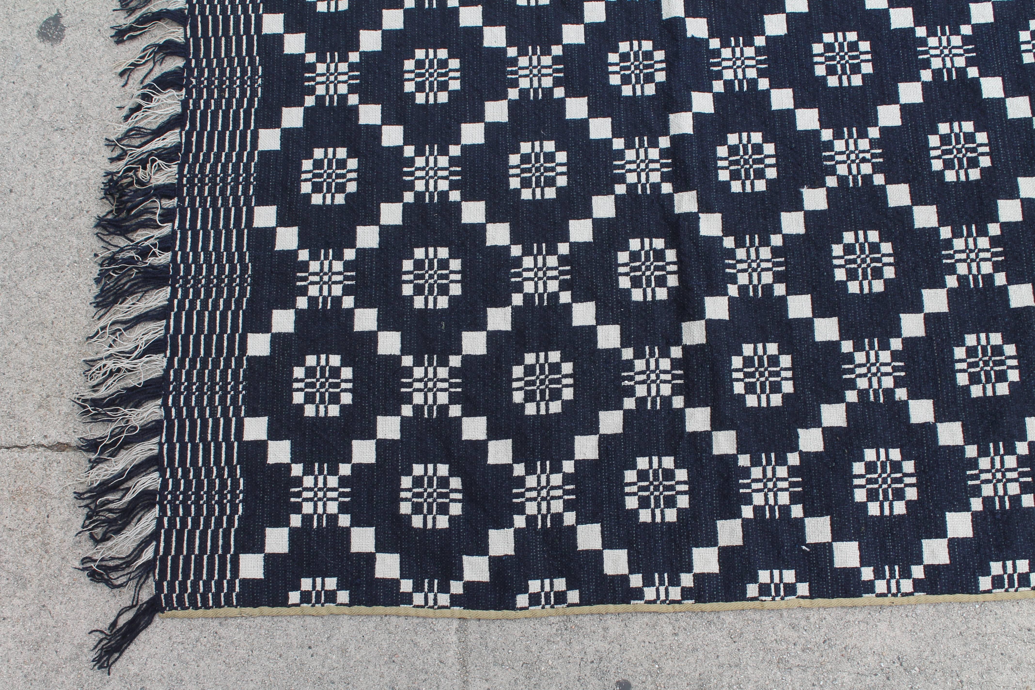 This pristine 18th century handwoven coverlet in dark indigo blue and white is in pristine condition and retains the original fringe. The reverse is white and blue same pattern. This fantastic coverlet has fringe on all three sides with a khaki